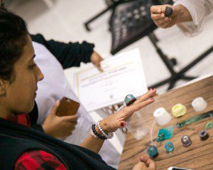 Nuqat co-founder Hussah Al Humaidhi tries on handmade jewelry by local artists. 