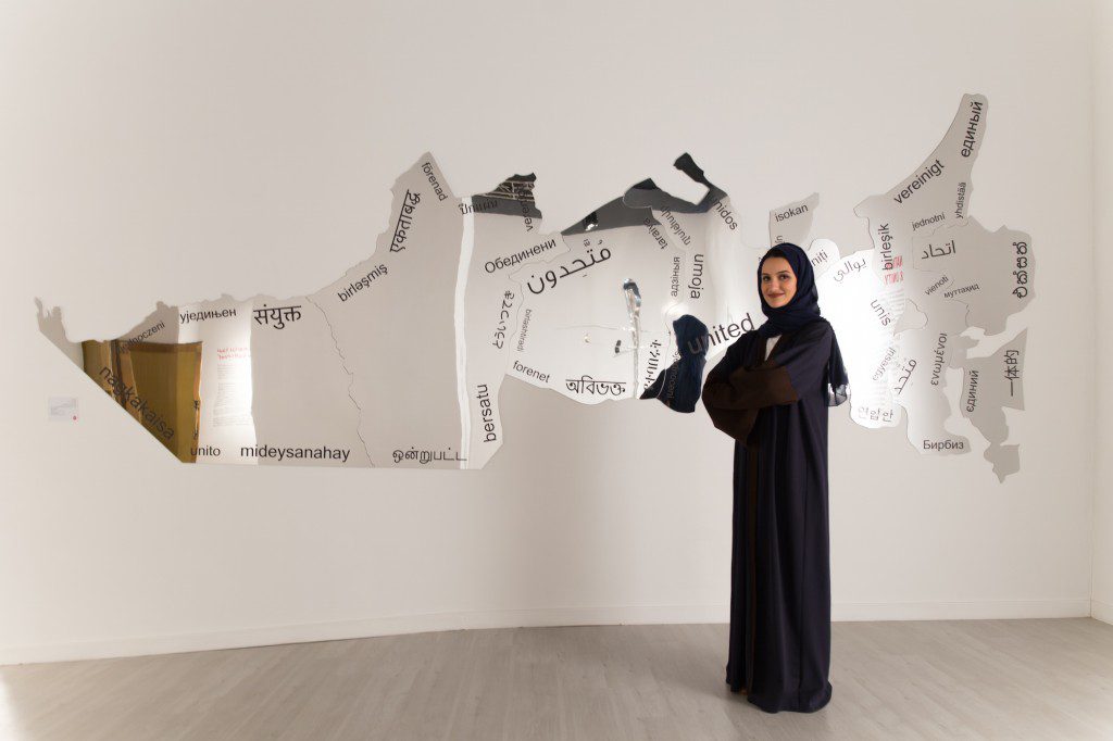 Artist Amna Al Dabbagh with her piece, "United." Photo courtesy of Chiragh Bhatia.