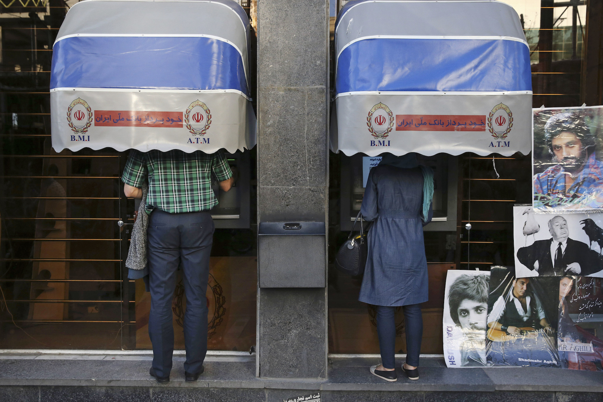 Iranians use ATM machines of Bank Melli Iran in downtown Tehran, Iran, April 4, 2015. (AP Photo/Vahid Salemi)