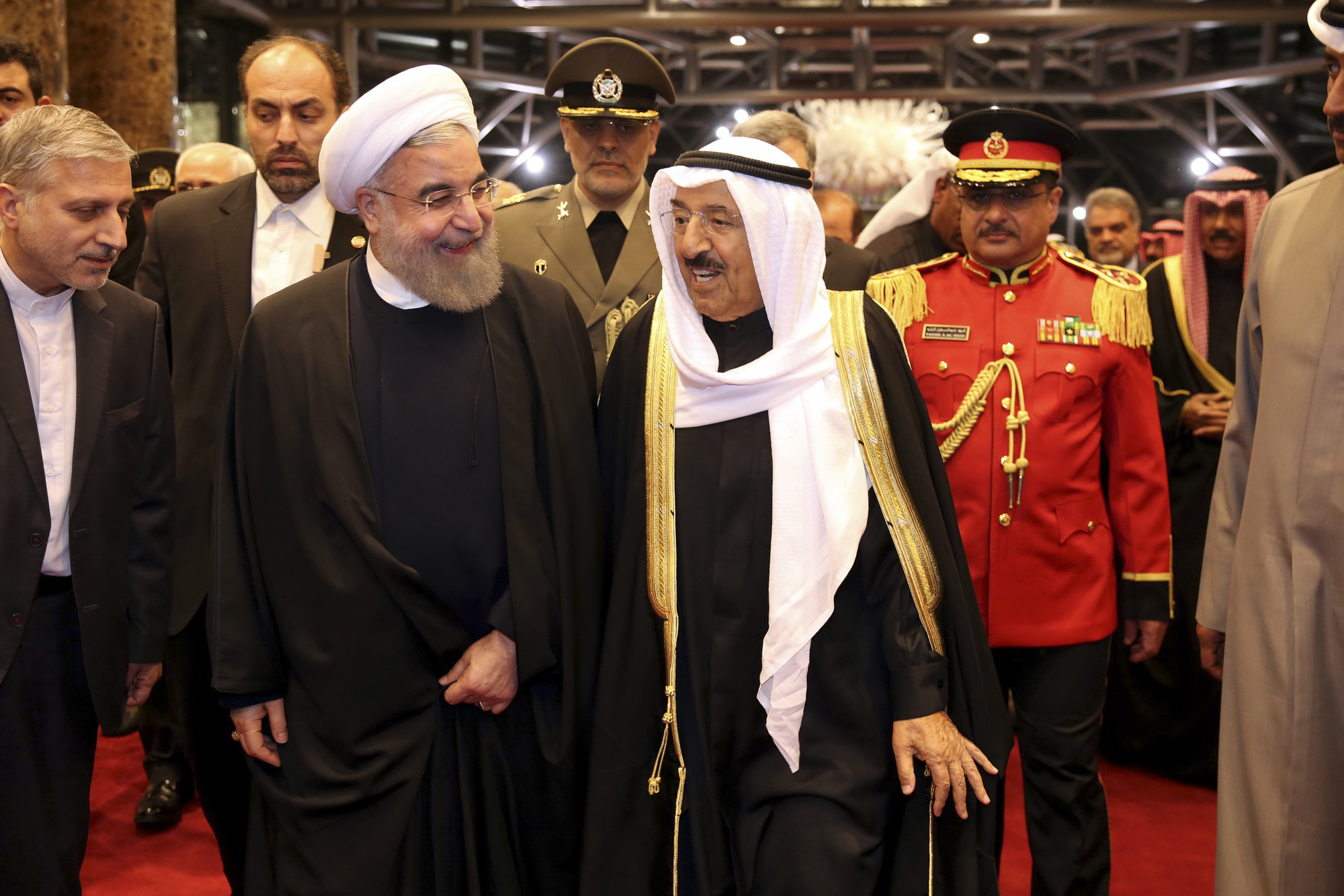 Iranian President Hassan Rouhani, center left, is welcomed by Kuwaiti Emir Sabah al-Ahmed al-Sabah, center, at Kuwait International Airport, Feb. 15, 2017. (Iranian Presidency Office via AP)