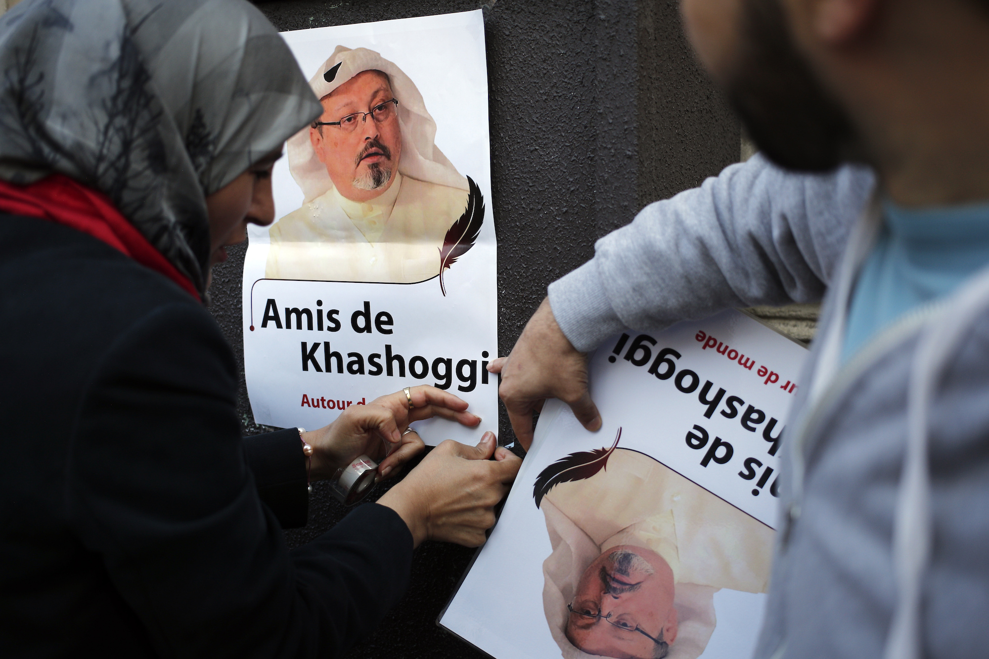 Activists carry posters of Jamal Khashoggi reading "Friends of Khashoggi around the world" as part of a protest near the Saudi embassy, in Paris, France, Oct. 25, 2018. (AP Photo/Francois Mori)