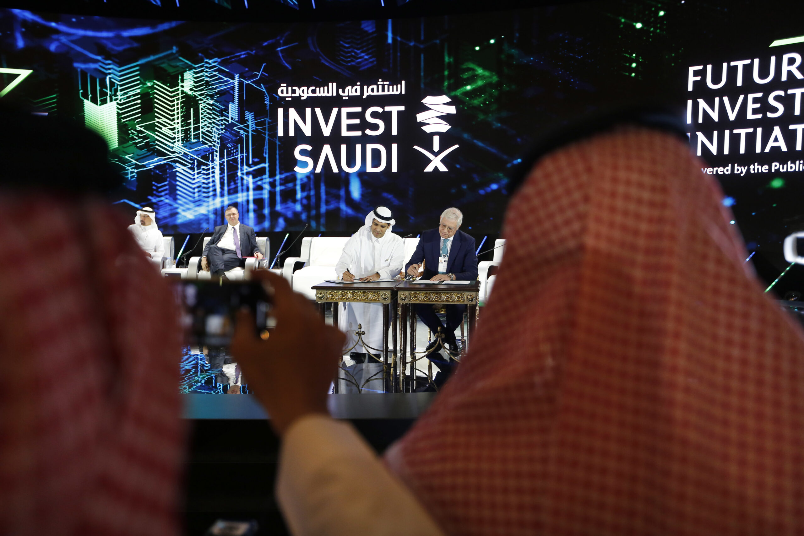 The executive president of Haramain High Speed Railway and a Saudi official sign accords during the Future Investment Initiative conference, Riyadh, Saudi Arabia, Oct. 23, 2018. (AP Photo/Amr Nabil)