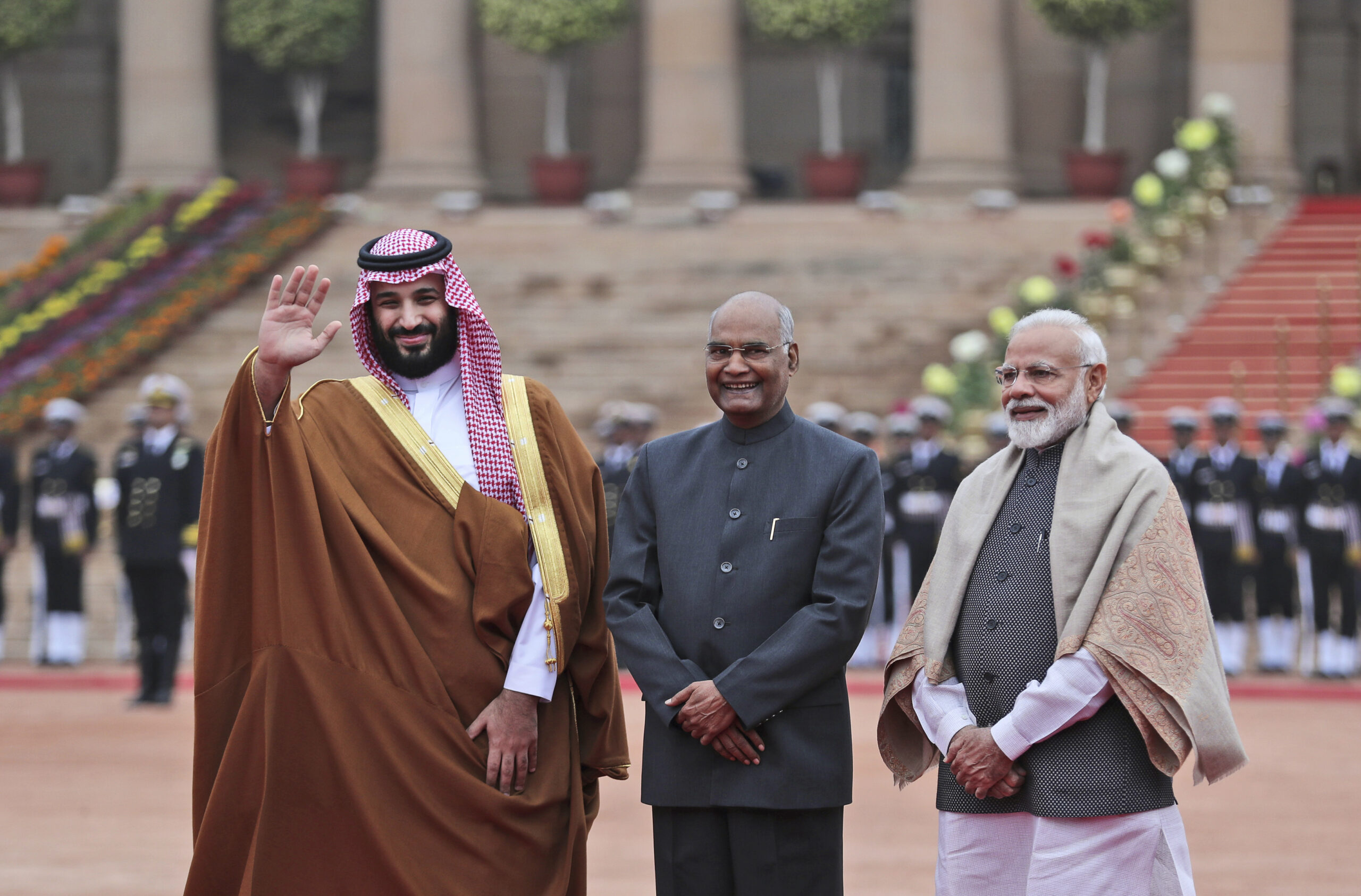 Saudi Arabia's Crown Prince Mohammed bin Salman, waves to the media, with Indian Prime Minister Narendra Modi, right, and Indian President Ram Nath Kovind standing beside him during a ceremonial welcome in New Delhi, India, Feb. 20. (AP Photo/Manish Swarup)