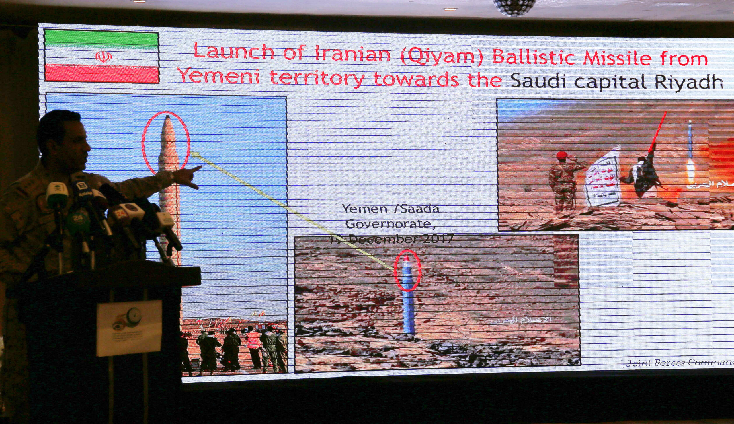 Saudi Colonel Turki al-Malki, spokesperson for the Saudi-led coalition in Yemen, points to a screen showing what he said was evidence of Iranian intervention and support to Yemen's Houthi rebels during a news conference in Mecca, Saudi Arabia, May 31. (AP Photo/Amr Nabil)