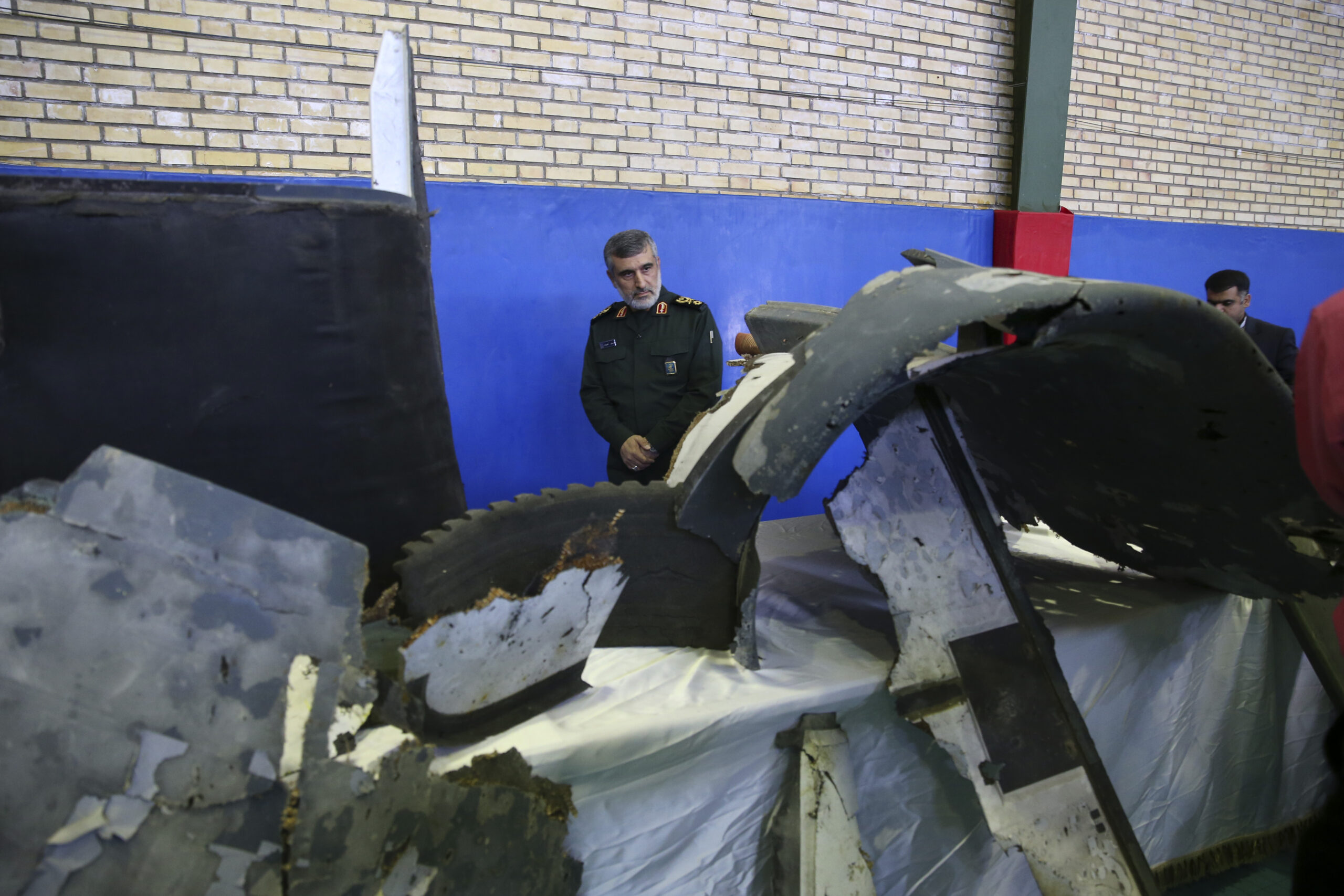 Iranian General Amir Ali Hajizadeh, head of the Islamic Revolutionary Guard Corp' aerospace division, looks at debris from what the division describes as the U.S. drone which was shot down on June 20, Tehran, Iran, June 21. (Meghdad Madadi/Tasnim News Agency/via AP)