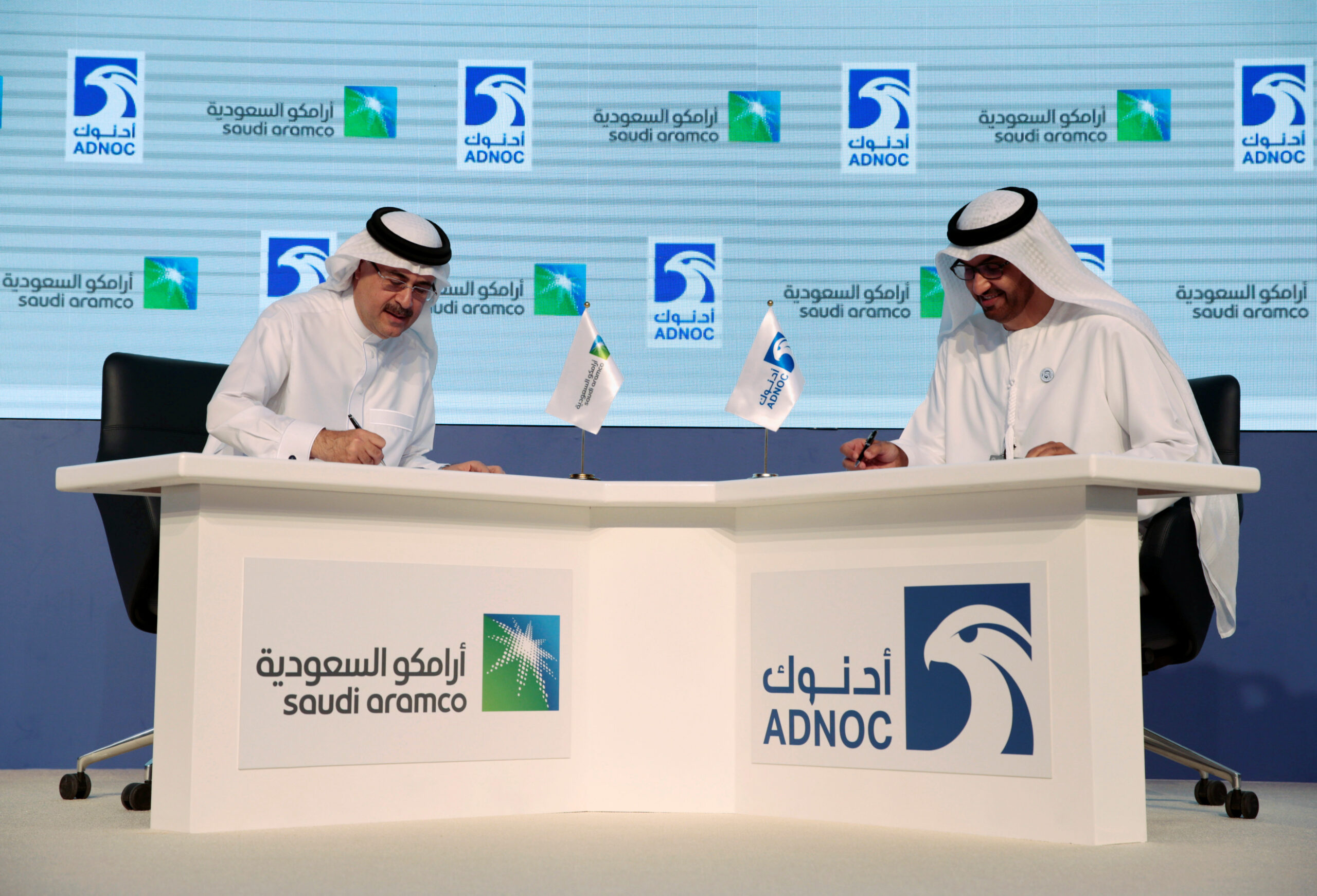 Saudi Aramco President and Chief Executive Officer Amin Nasser, left, and ADNOC Chief Executive Officer Sultan Ahmed Al Jaber are seen during a signing ceremony at the Abu Dhabi International Petroleum Exhibition and Conference in Abu Dhabi, United Arab Emirates, November 12, 2018. (REUTERS/Christopher Pike)