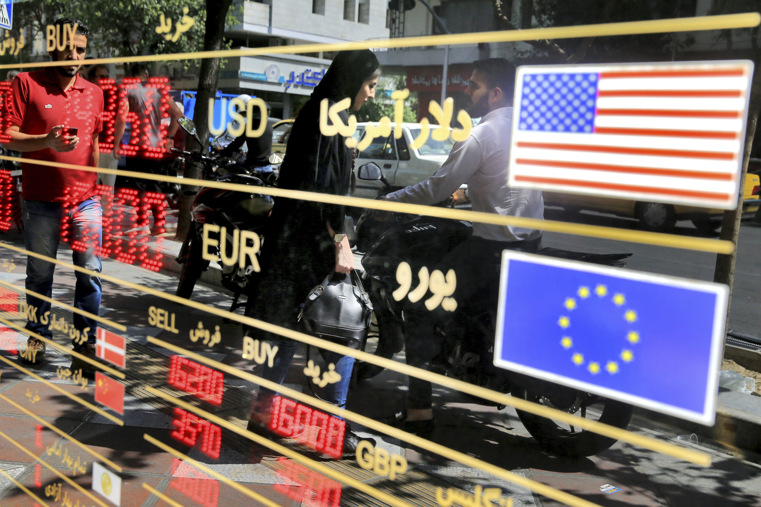 Various currency rates are displayed at a window of an exchange shop in downtown Tehran, Iran, Sept. 5, 2018. (AP Photo/Ebrahim Noroozi)