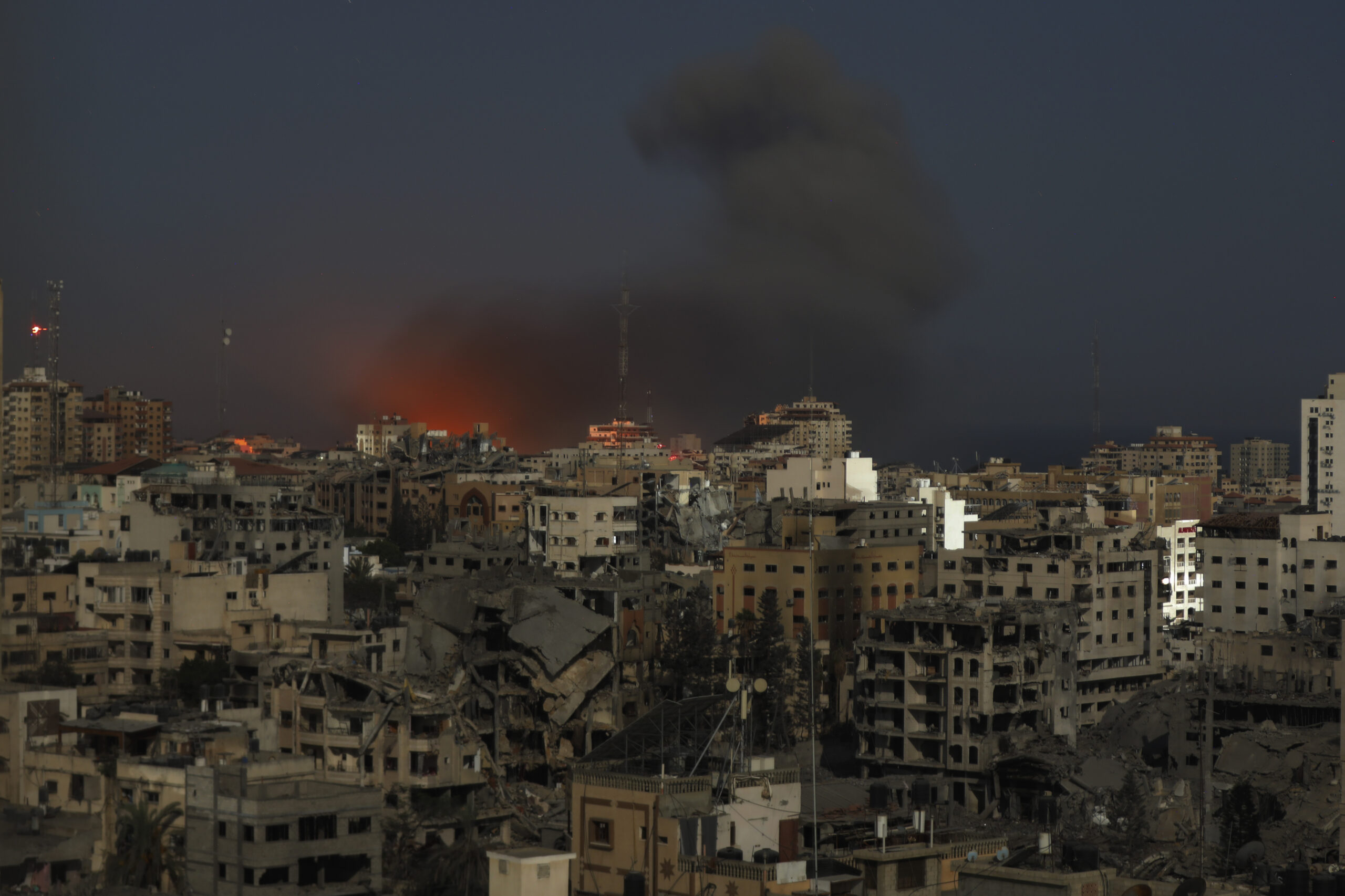 Long exposure photo shows destroyed buildings with fire and smoke rise following Israeli airstrikes on Gaza City, Oct. 30. (AP Photo/Abed Khaled)