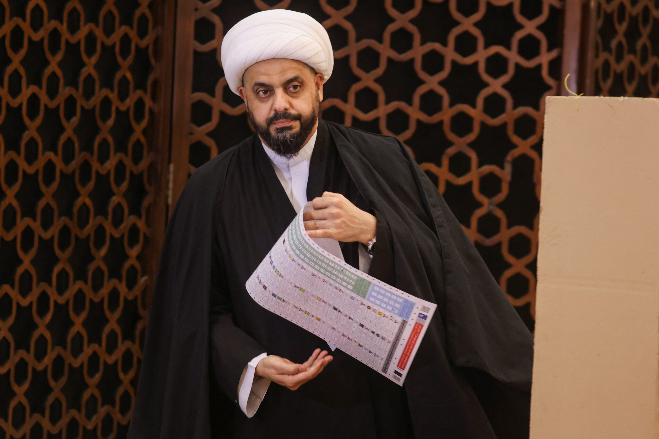 Qais Khazali, leader of Asaib Ahl al-Haq, holds a ballot sheet as he votes during Iraq's provincial council elections, at a polling station in Baghdad, Iraq, December 18, 2023. (REUTERS/Ahmed Saad)