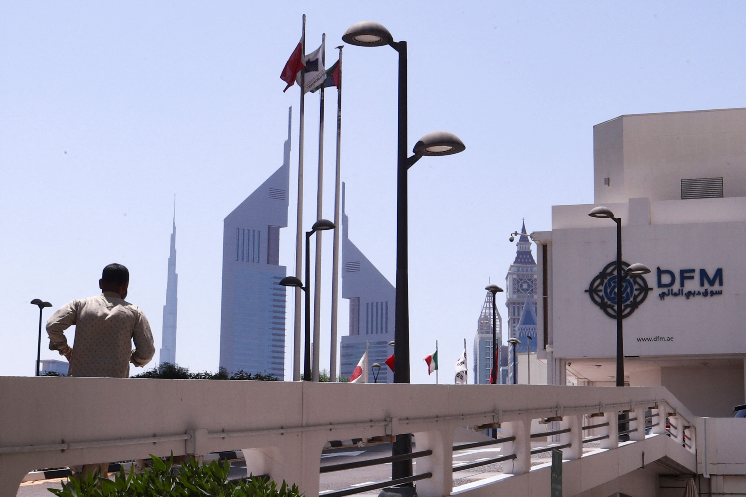 A person runs outside the Dubai Financial Market building in Dubai, United Arab Emirates, March 20, 2023. (REUTERS/Amr Alfiky)