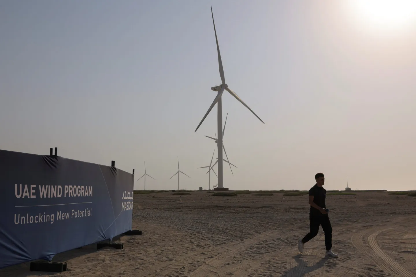 A person walks in Masdar's wind farm on Sir Bani Yas Island, in Abu Dhabi, United Arab Emirates, September 28, 2023. (REUTERS/Amr Alfiky)