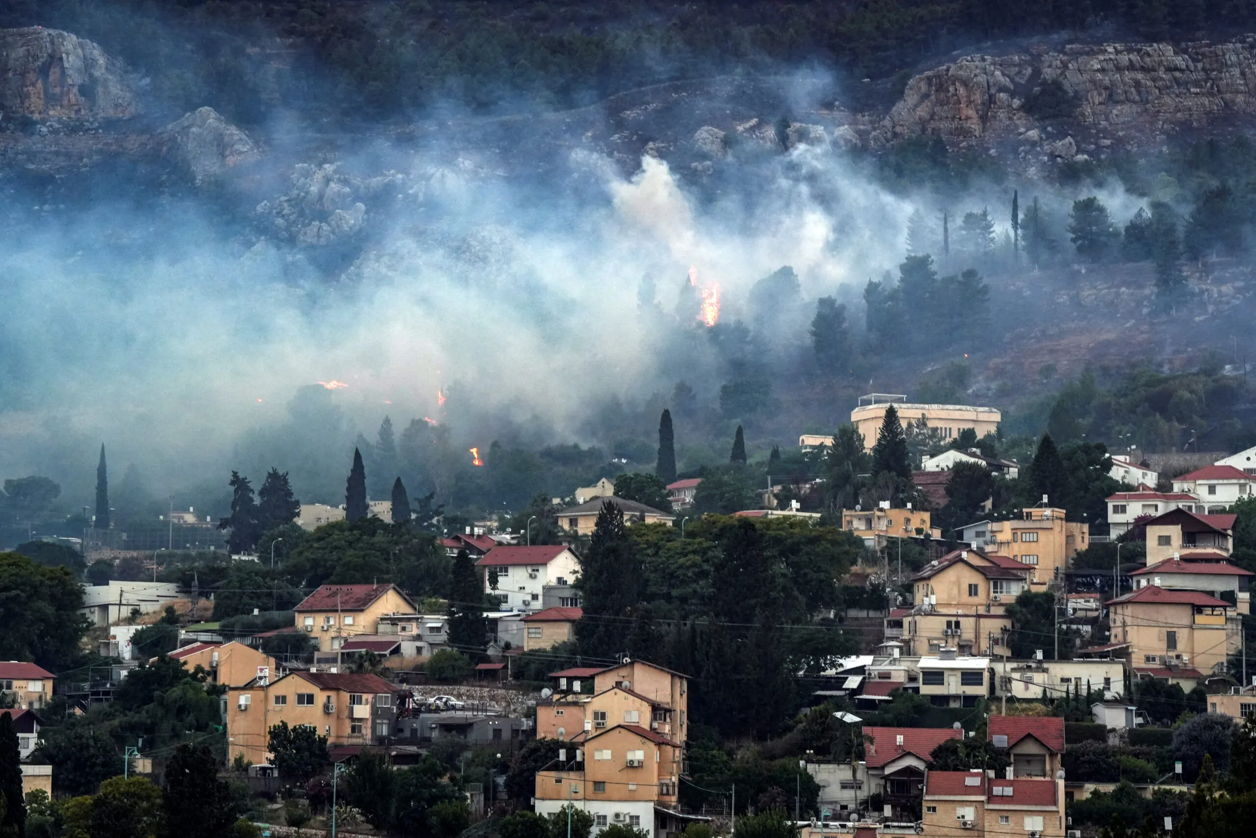 Smoke and fire covers the area following rocket attacks from Lebanon, amid ongoing cross-border hostilities between Hezbollah and Israeli forces, near Kiryat Shmona, Israel, close to its border with Lebanon, June 3. (REUTERS/Ayal Margolin)