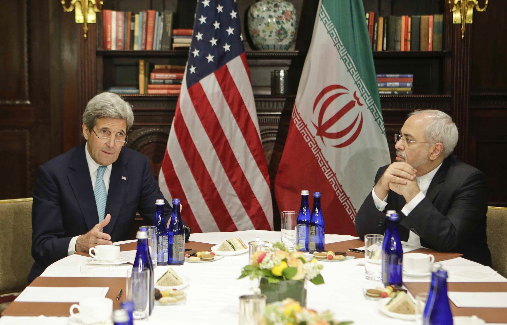 U.S. Secretary of State John Kerry, left, speaks to the media as Iranian Foreign Minister Mohammad Javad Zarif listens Friday, April 22, 2016, in New York. (AP Photo/Frank Franklin II)