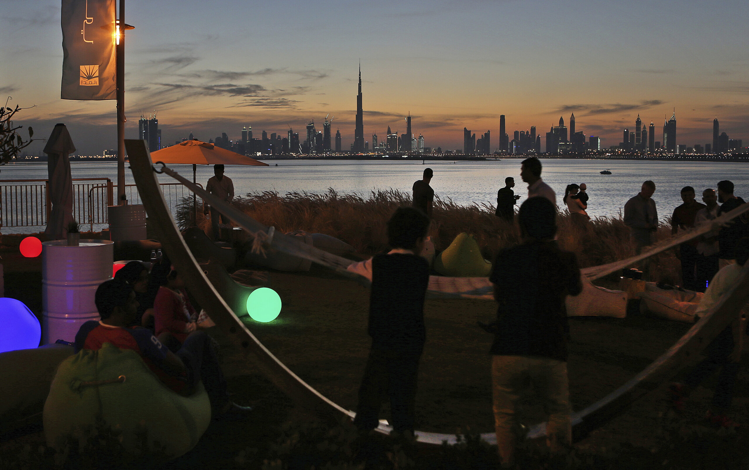 People watch the sunset over the city skyline, Dubai, United Arab Emirates, March 4, 2016. (AP Photo/Kamran Jebreili)