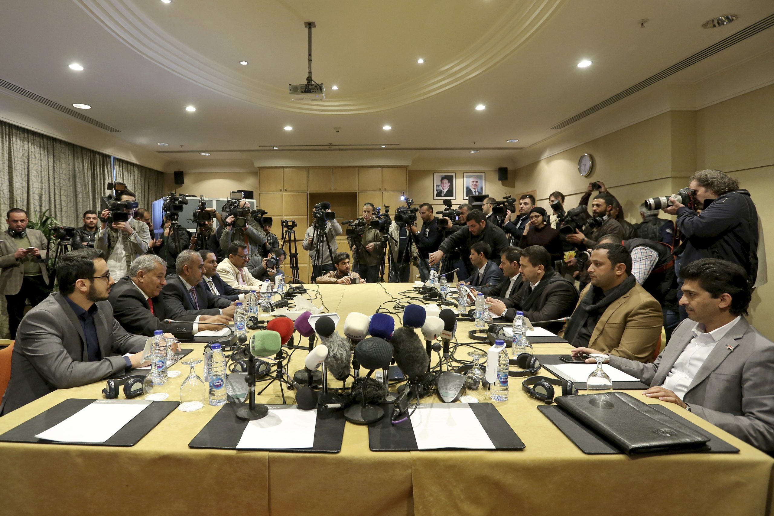 The Houthi rebel delegation, right, and delegates of the internationally recognized Yemeni government hold talks on Yemen, in Amman, Jordan, Feb. 5, 2019. (AP Photo/Raad Adayleh)
