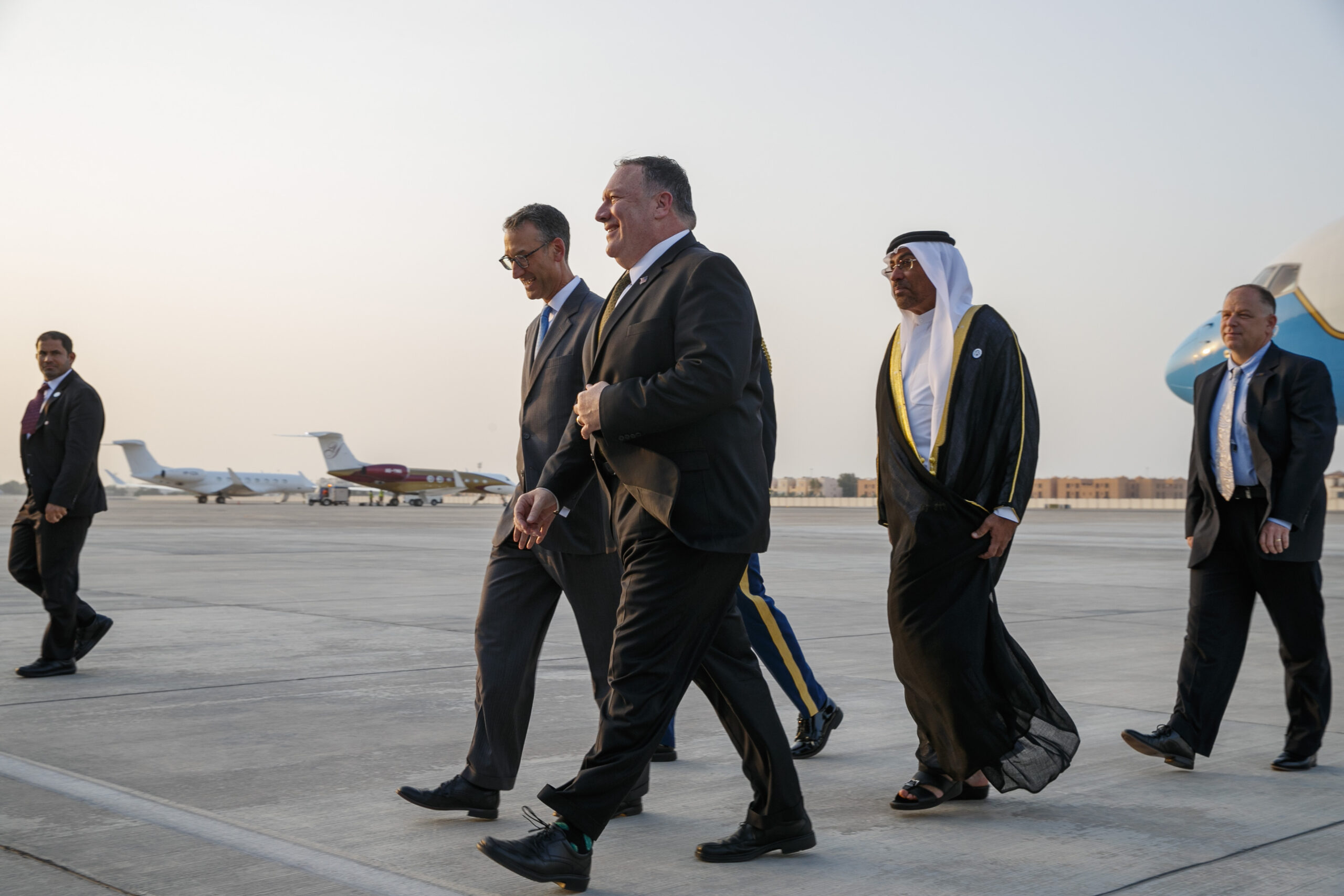 U.S. Secretary of State Mike Pompeo, center, walks with U.S. Chargé d'Affaires Steve Bondy, left, and UAE Minister of State Ahmed al-Sayegh, right, as Pompeo arrives in Abu Dhabi, United Arab Emirates, for talks on Iran, June 24. (AP Photo/Jacquelyn Martin)