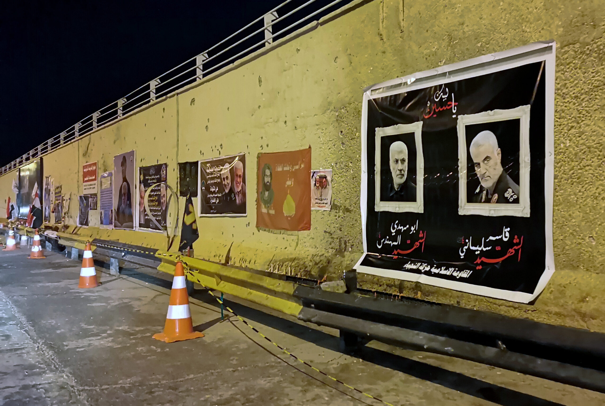 Posters of Islamic Revolutionary Guard Corps Quds Force commander Major General Qassim Suleimani and Kataib Hezbollah leader Abu Mahdi al-Muhandis, both killed in a U.S. strike in January, hang in Baghdad, Iraq, Jan. 16. (AP Photo/Hadi Mizban)