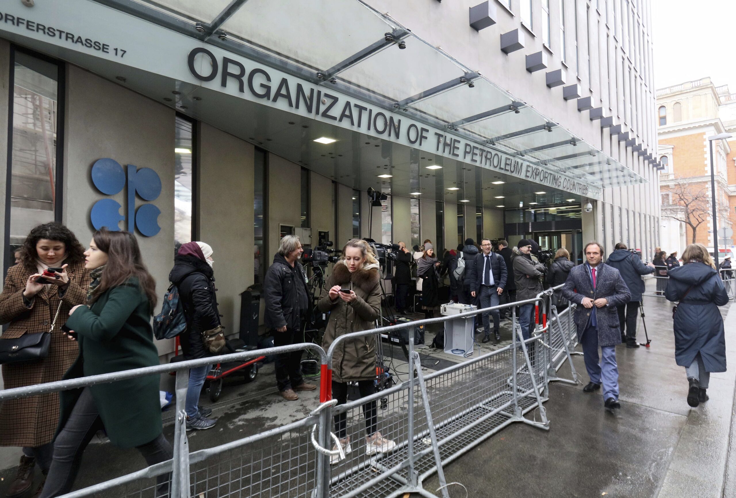 People stand in front of OPEC's headquarters in Vienna, Austria, March 6. (AP Photo/Ronald Zak)