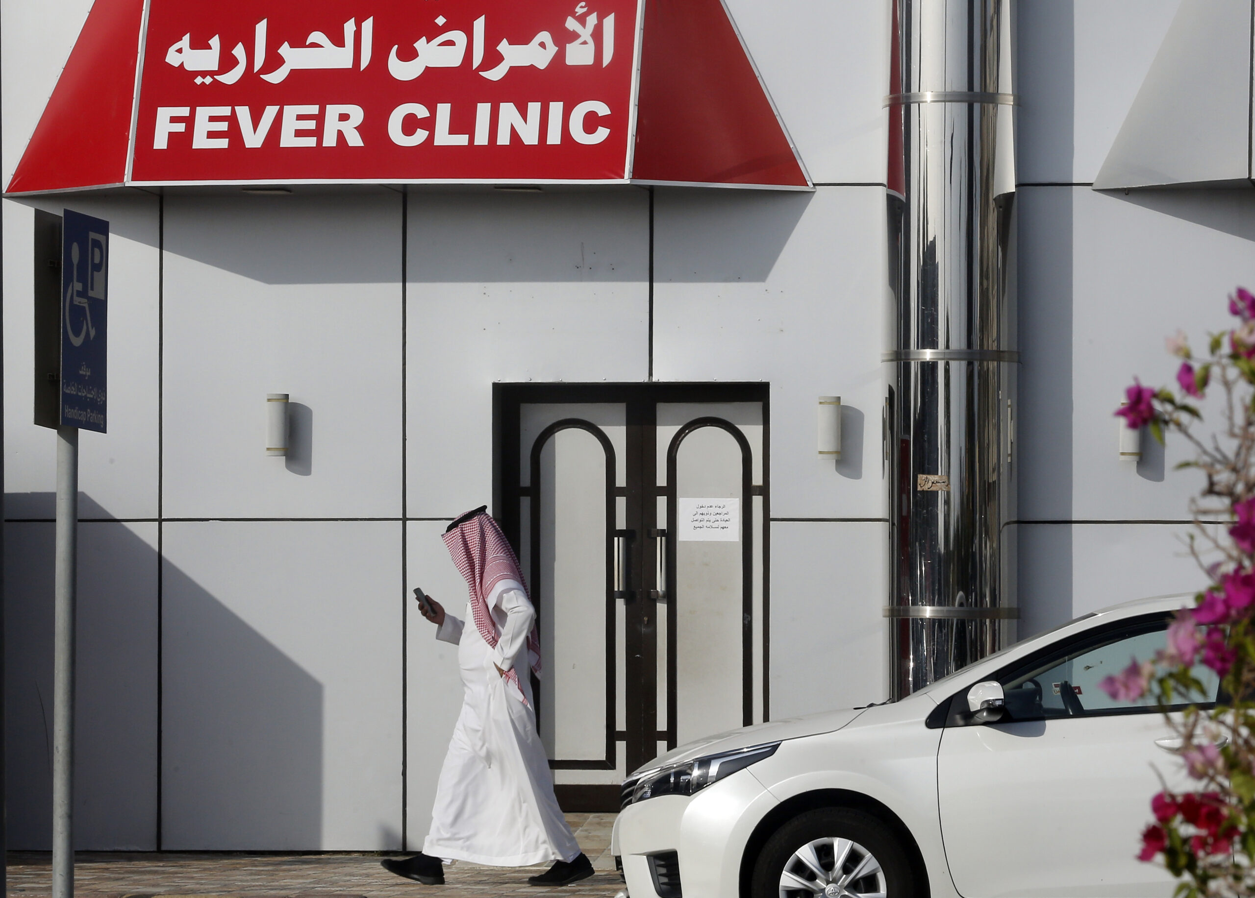 A Saudi man walks in front of a fever clinic serving individuals showing coronavirus symptoms, Jeddah, Saudi Arabia, July 9. (AP Photo/Amr Nabil)