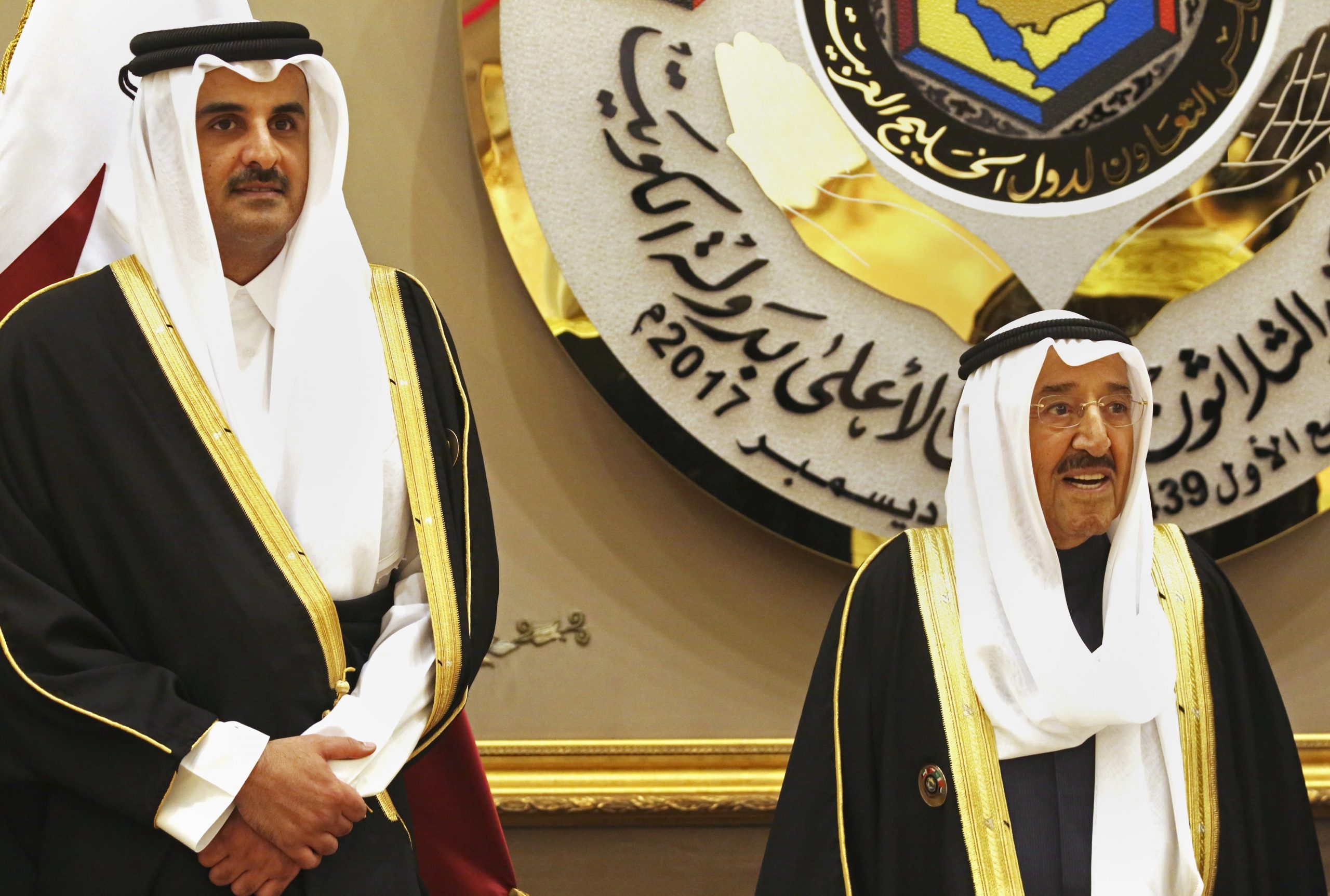 Qatari Emir Tamim bin Hamad al-Thani, left, and Kuwait's then-Emir, Sabah al-Ahmed al-Sabah, right, stand for a group photograph at the Gulf Cooperation Council summit in Kuwait, Dec. 5, 2017. (AP Photo/Jon Gambrell)
