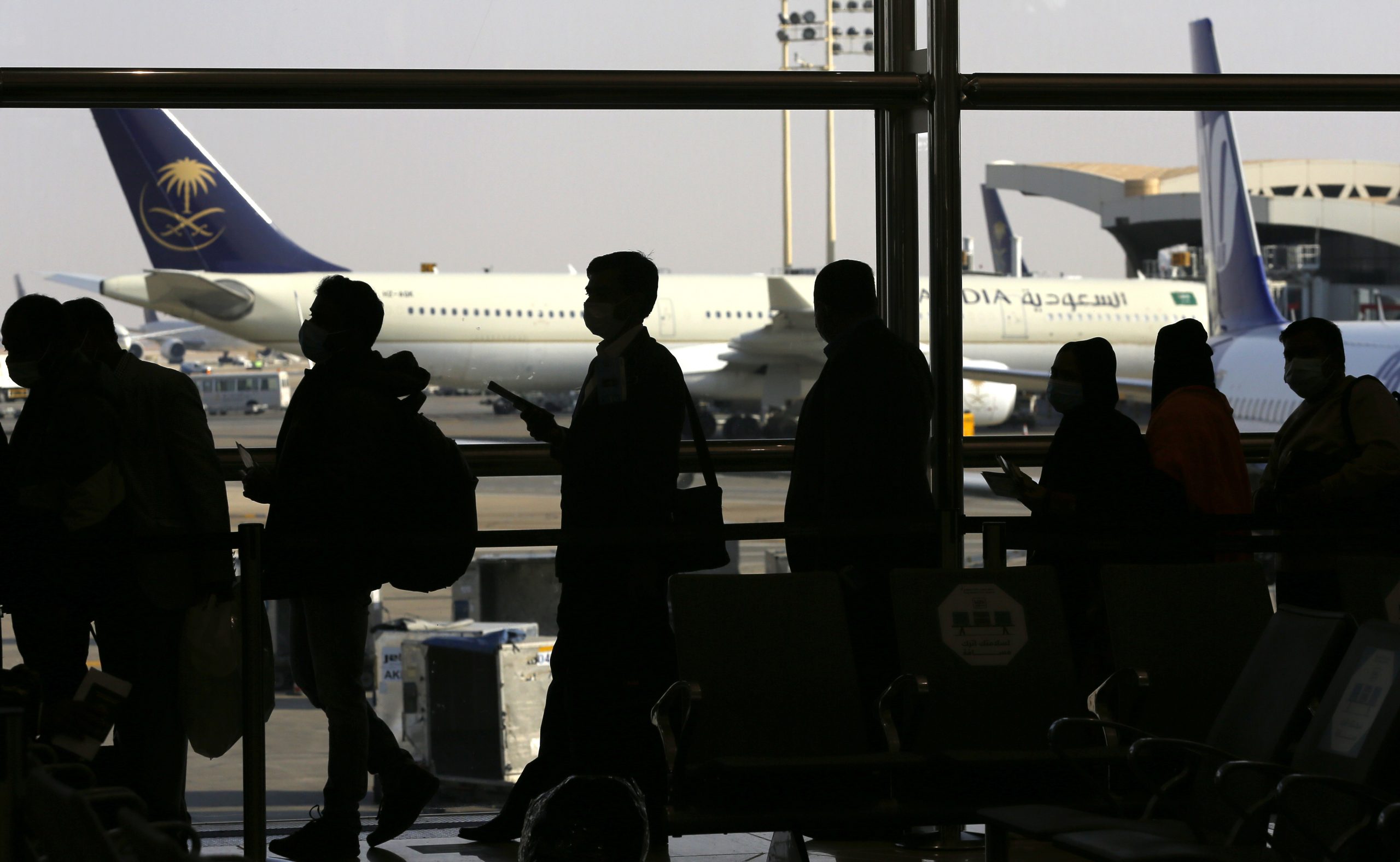 Passengers line up to check in for their flight at King Khalid Airport in Riyadh, Saudi Arabia, Jan. 11.(AP Photo/Amr Nabil)