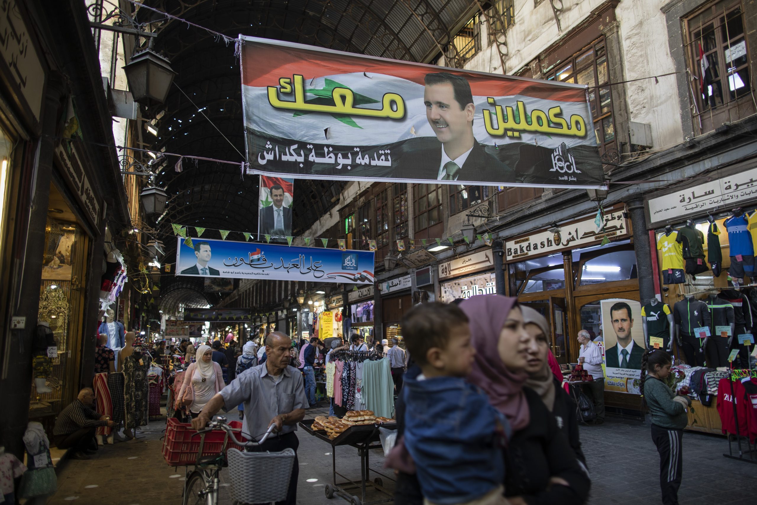 Posters Syrian President Bashar al-Assad hang in the Hamadiyah market in the Old City of Damascus, Syria, May 24. (AP Photo/Hassan Ammar)