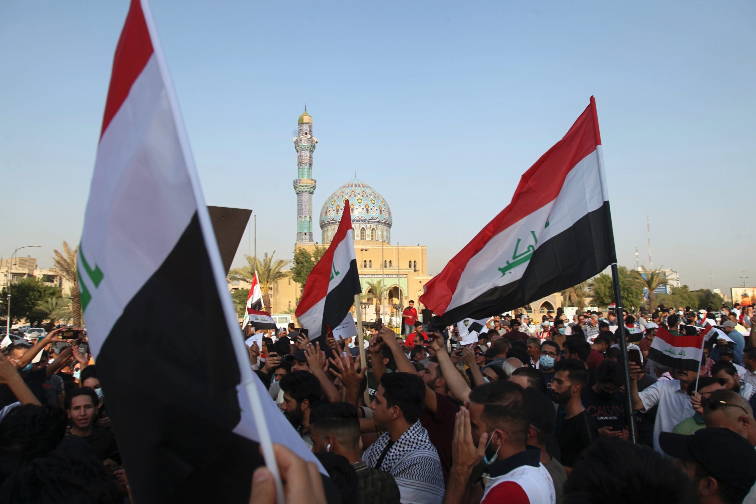 Protesters wave Iraqi flags during a protest in Baghdad, Iraq, July 18. (AP Photo/Khalid Mohammed)
