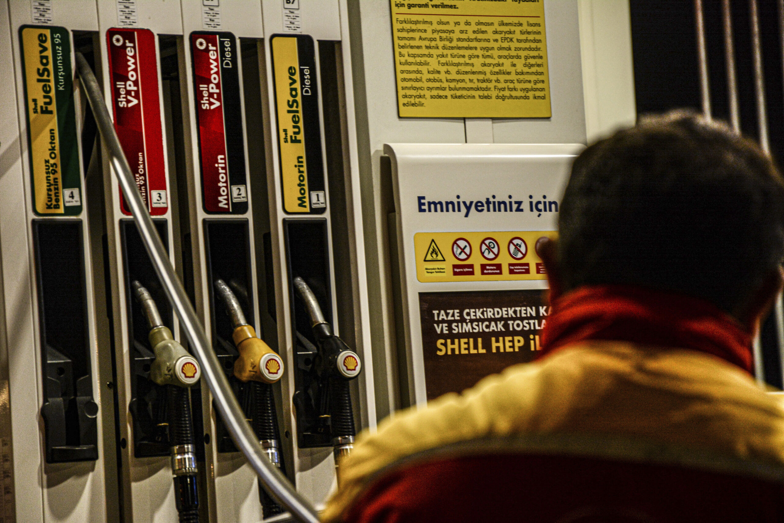 An employee stands in front of a fuel pump at a gas station, Istanbul, Turkey, March 2. (Gocheryimagery/MediaPunch /IPX)