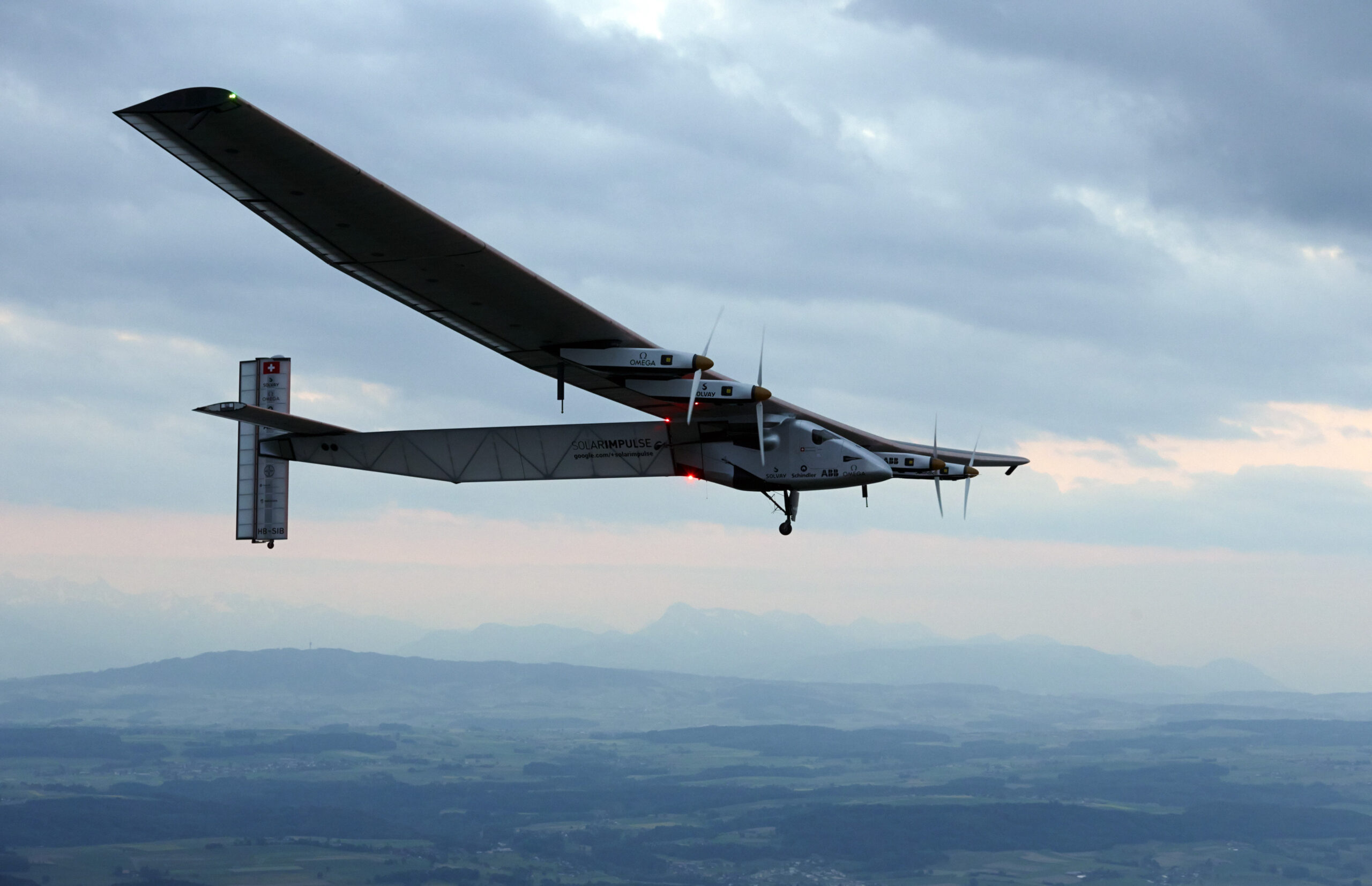 Test pilot Markus Scherdel steers the solar-powered Solar Impulse 2 aircraft for its maiden flight at its base in Payerne, Switzerland before its historic journey in March from Abu Dhabi, United Arab Emirates, June 2, 2014. (AP Photo/Denis Balibouse)