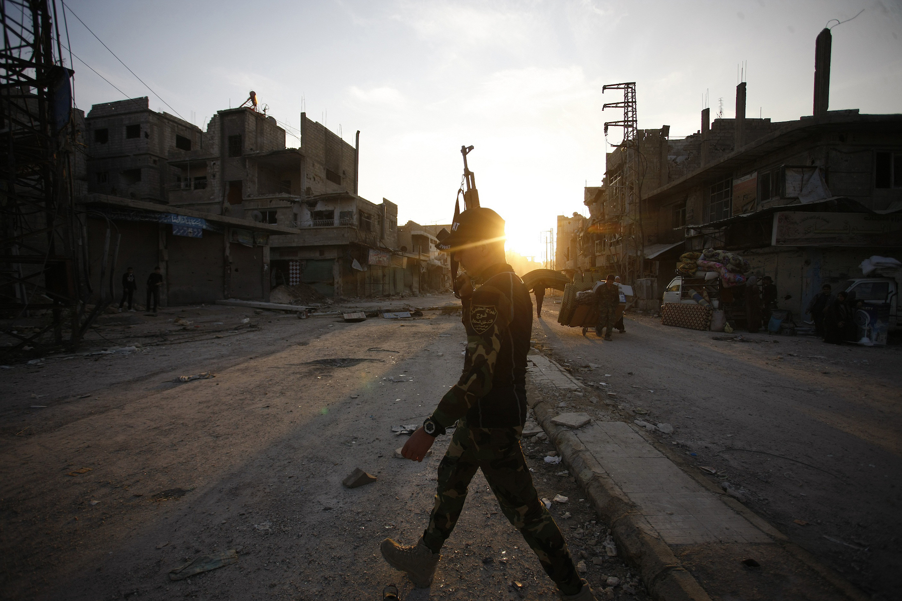 An Iraqi Shia fighter patrols in the town of Hejeira in the countryside of Damascus, Syria, Nov. 21, 2013. (AP Photo/Jaber al-Helo)