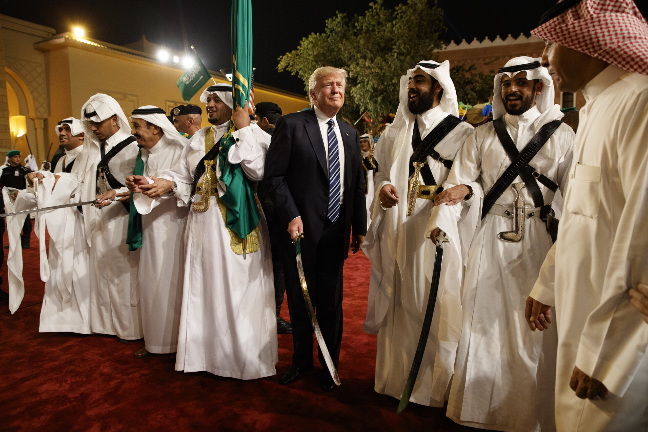 Then-President Donald J. Trump holds a sword and sways with traditional dancers during a welcome ceremony at Murabba Palace, Riyadh, Saudi Arabia, May 20, 2017. (AP Photo/Evan Vucci)