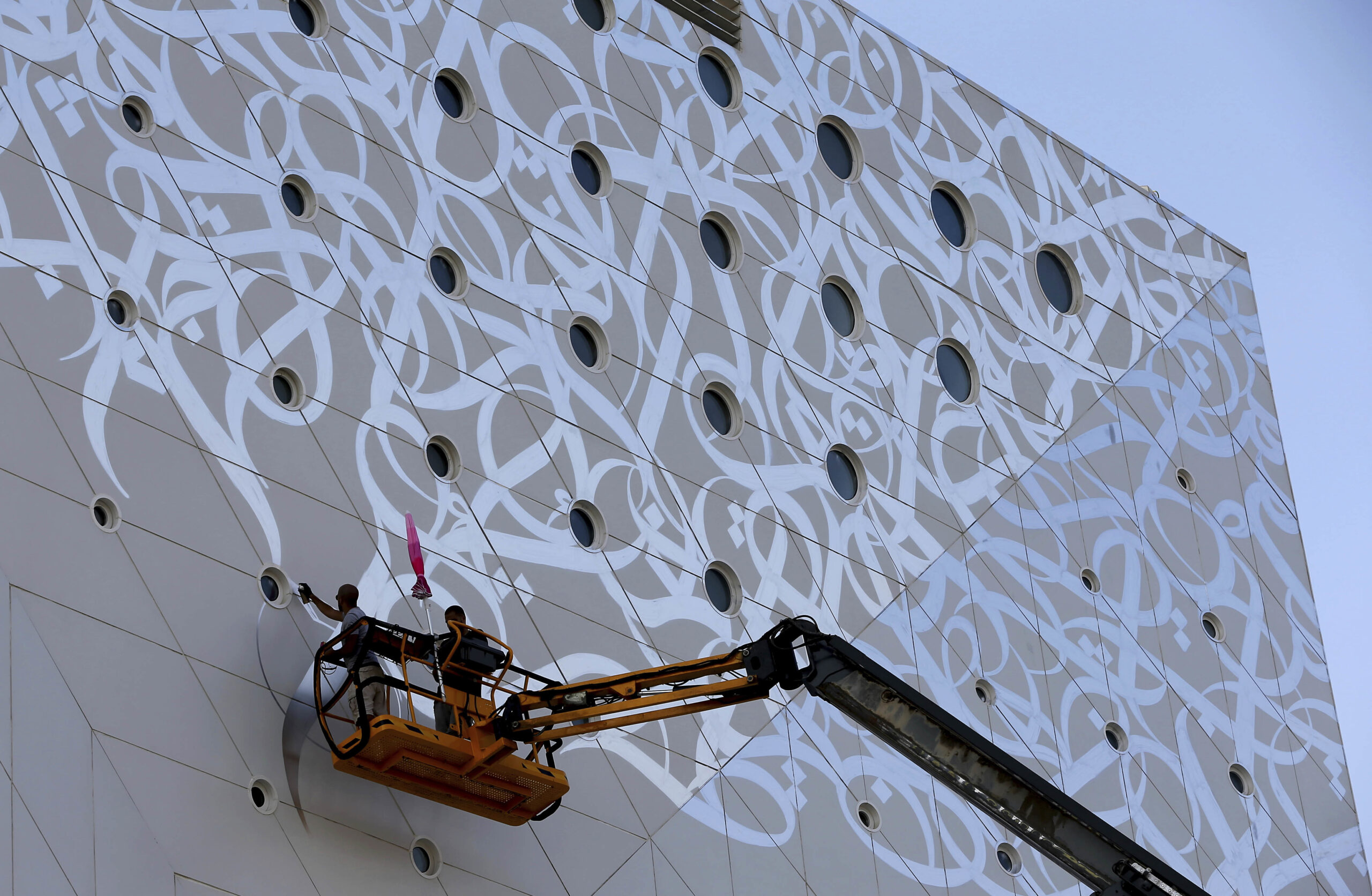 El Seed, French-Tunisian street artist, whose works incorporates traditional Arabic calligraphy which he calls calligraffiti, paints a mural as part of the Dubai Walls project in Dubai, United Arab Emirates, Monday, Oct. 17, 2016. (AP Photo/Kamran Jebreili)