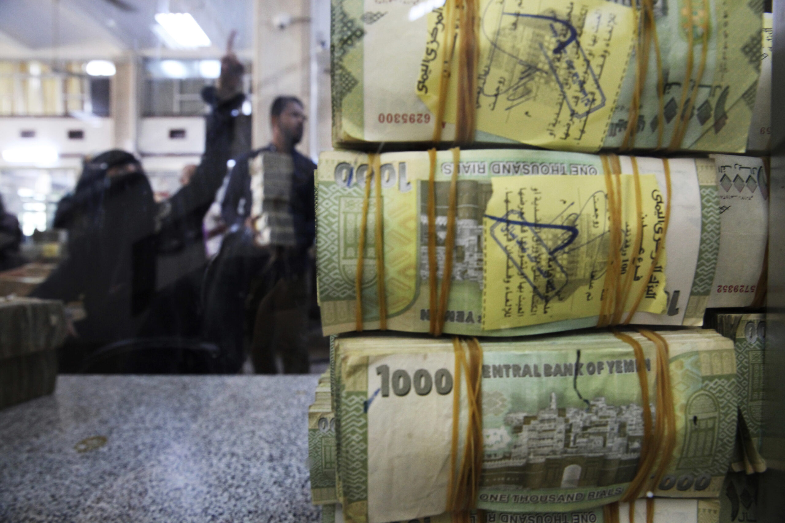 A stack of Yemeni rials rests on the counter at the Central Bank of Yemen's U.N.-recognized government in Aden, Yemen, Dec. 13, 2018. (AP Photo/Jon Gambrell)