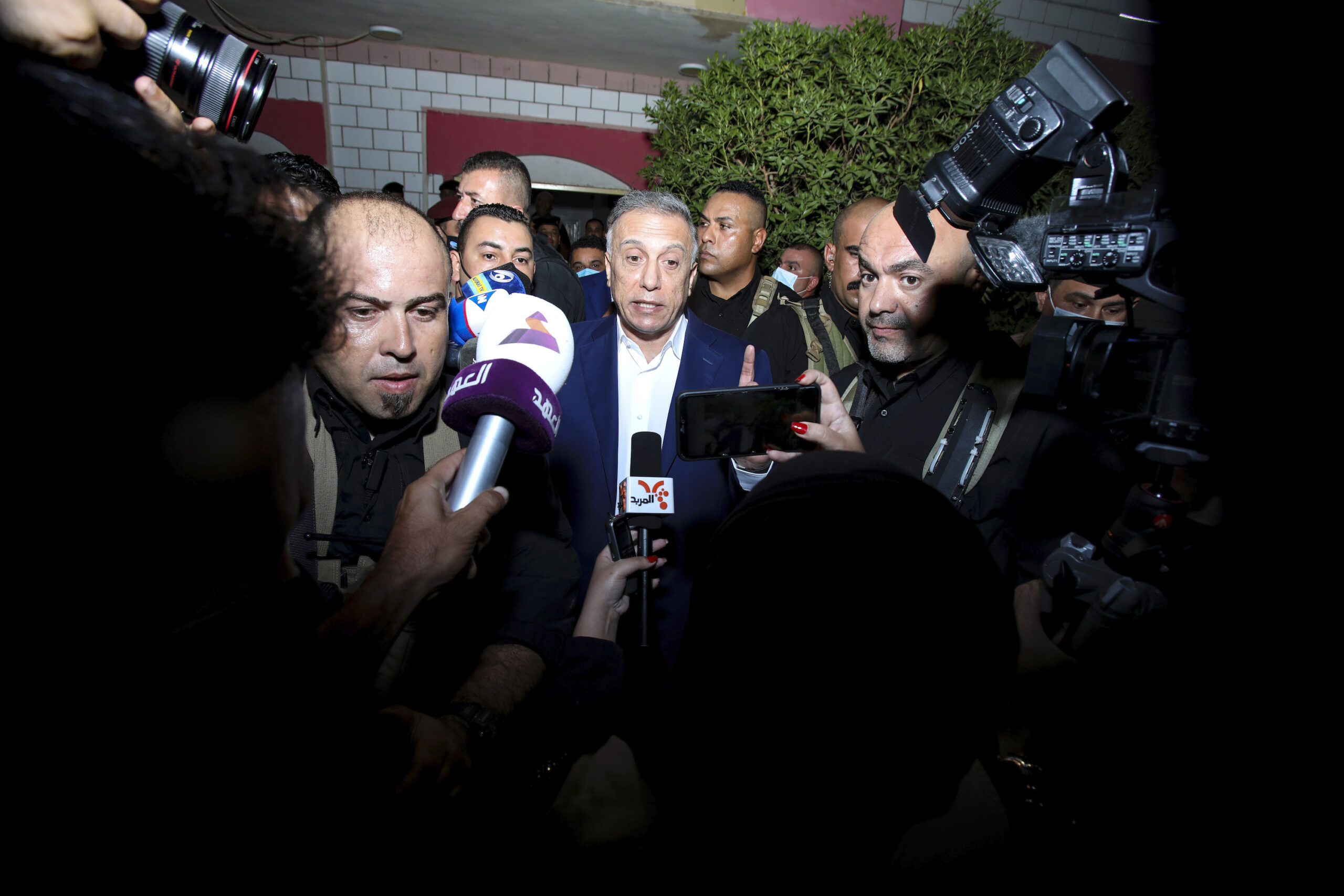 Iraqi Prime Minister Mustafa al-Kadhimi, center, speaks to journalists during his visit to Basra, Iraq, Aug. 22, 2020. (AP Photo/Nabil al-Jurani)