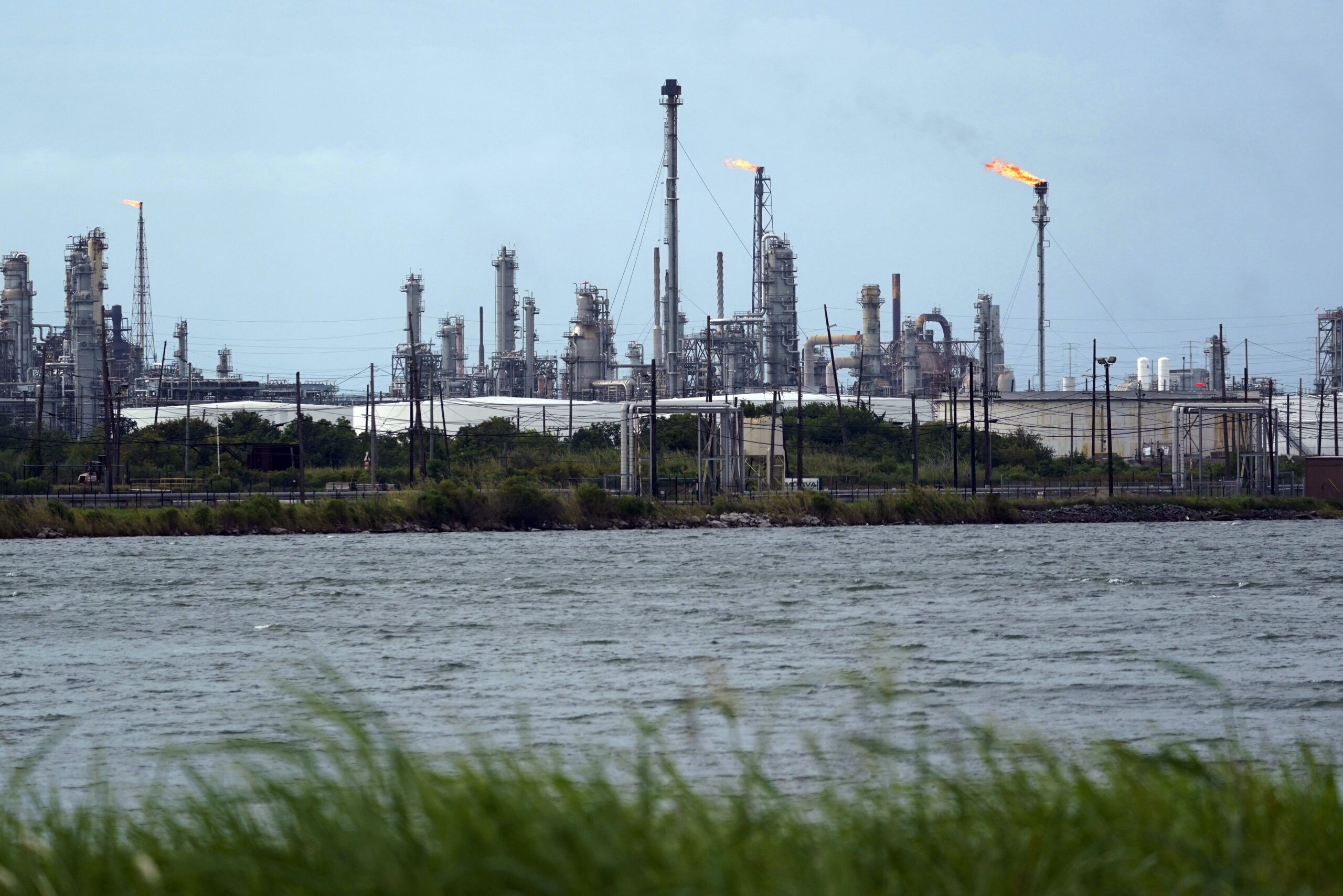A refinery is seen along the water, Aug. 26, 2020, in Port Arthur, Texas. (AP Photo/Eric Gay)