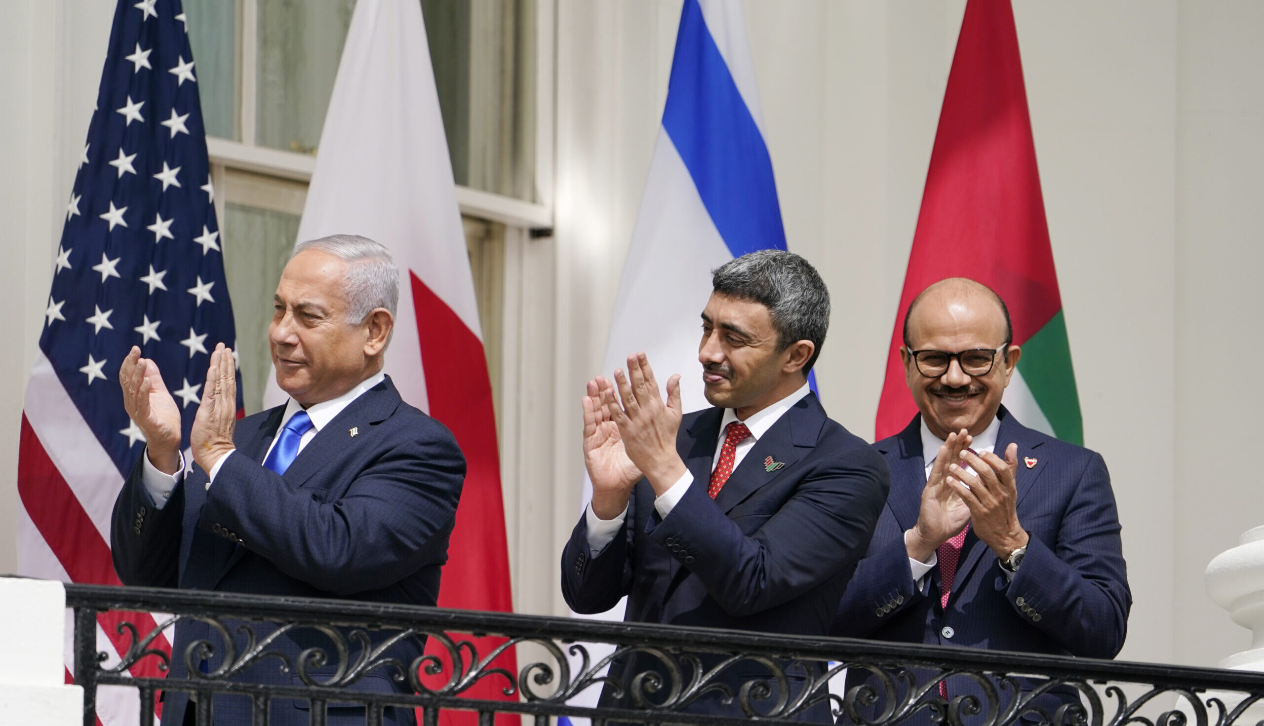 Israeli Prime Minister Benjamin Netanyahu, Emirati Foreign Minister Abdullah bin Zayed al-Nahyan, and Bahraini Foreign Minister Khalid bin Ahmed Al Khalifa stand on the Blue Room Balcony during the Abraham Accords signing ceremony on the South Lawn of the White House, Sept. 15, 2020, in Washington, DC. (AP Photo/Alex Brandon)