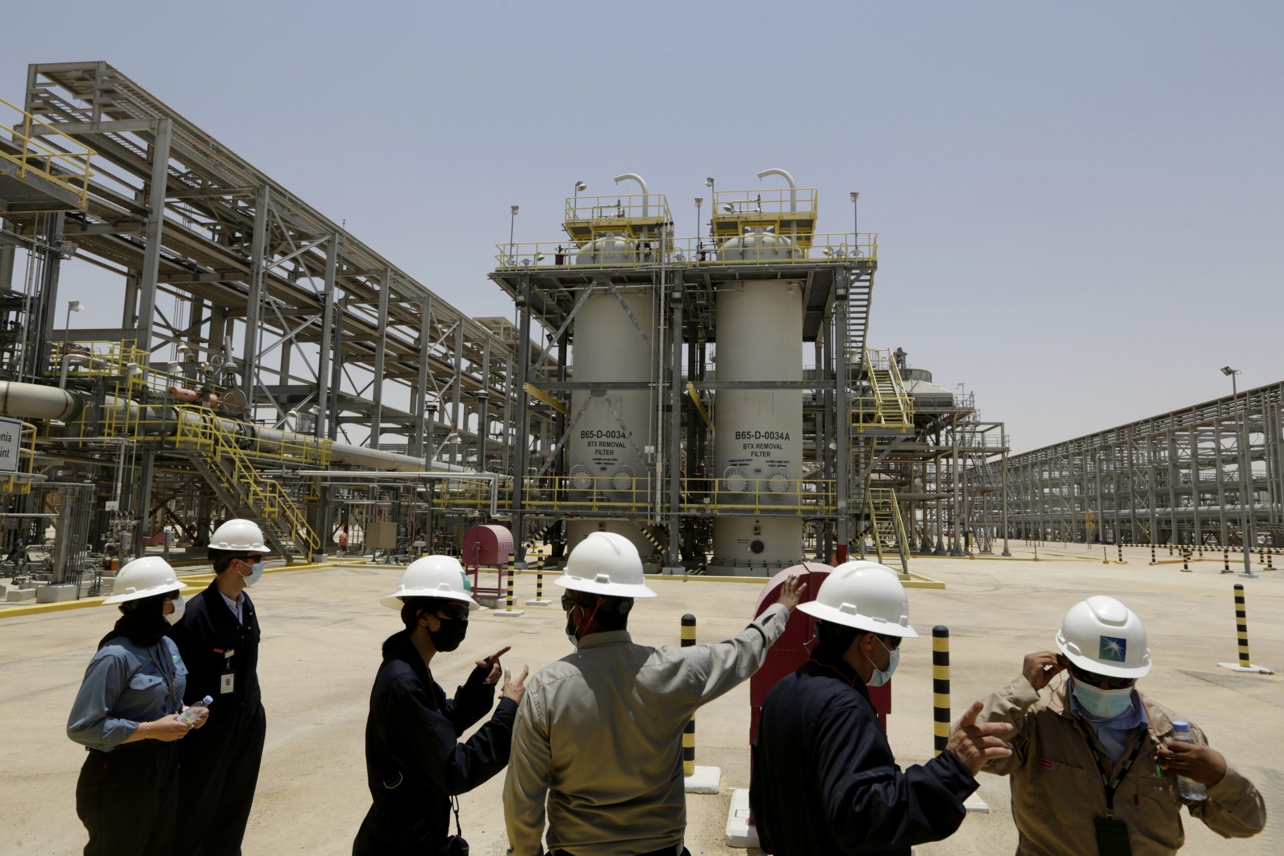 Saudi Aramco engineers and journalists look at the Hawiyah Natural Gas Liquids Recovery Plant in Hawiyah, in the Eastern Province of Saudi Arabia on June 28, 2021. (AP Photo/Amr Nabil)