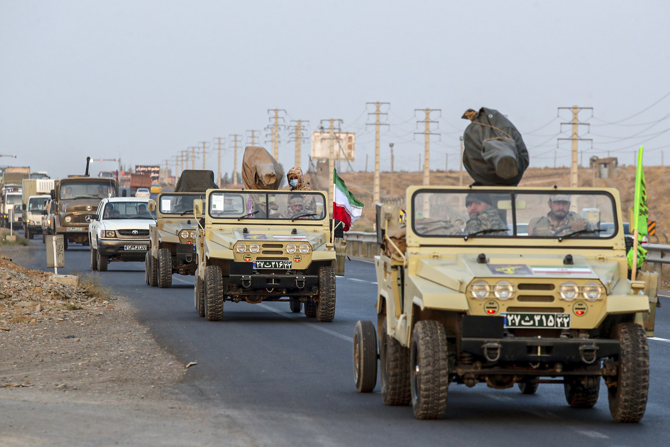Islamic Revolutionary Guard Corps vehicles move on a road in a maneuver in northwestern Iran, Oct. 18. (IRGC ground forces via AP)