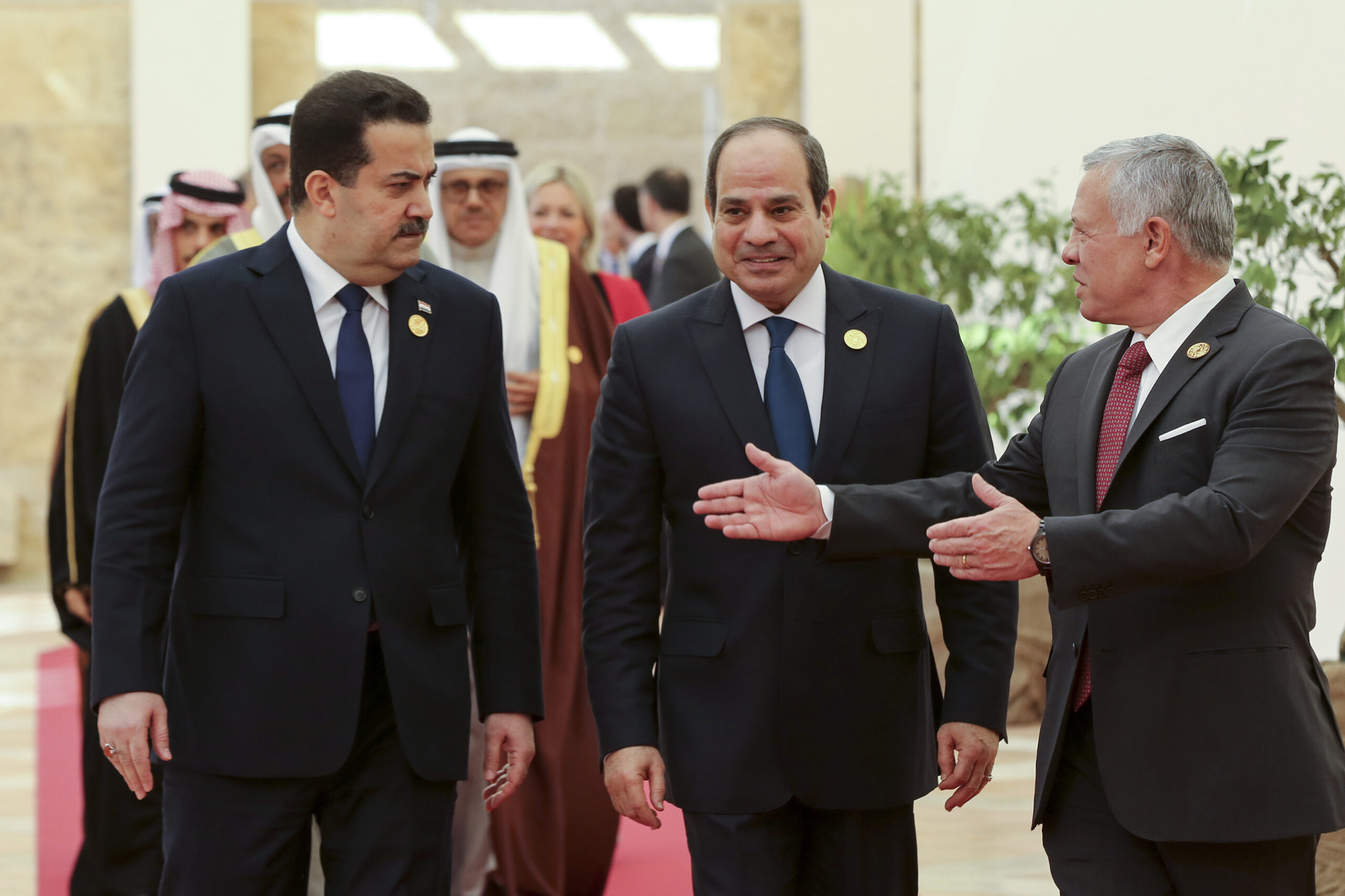 From the left, Iraqi Prime Minister Mohammed al-Sudani, Egyptian President Abdel Fattah al-Sisi, and Jordanian King Abdullah II talk during the second Baghdad Conference for Cooperation and Partnership, at the Dead Sea, Jordan, Dec. 20, 2022. (AP Photo/Raad Adayleh)