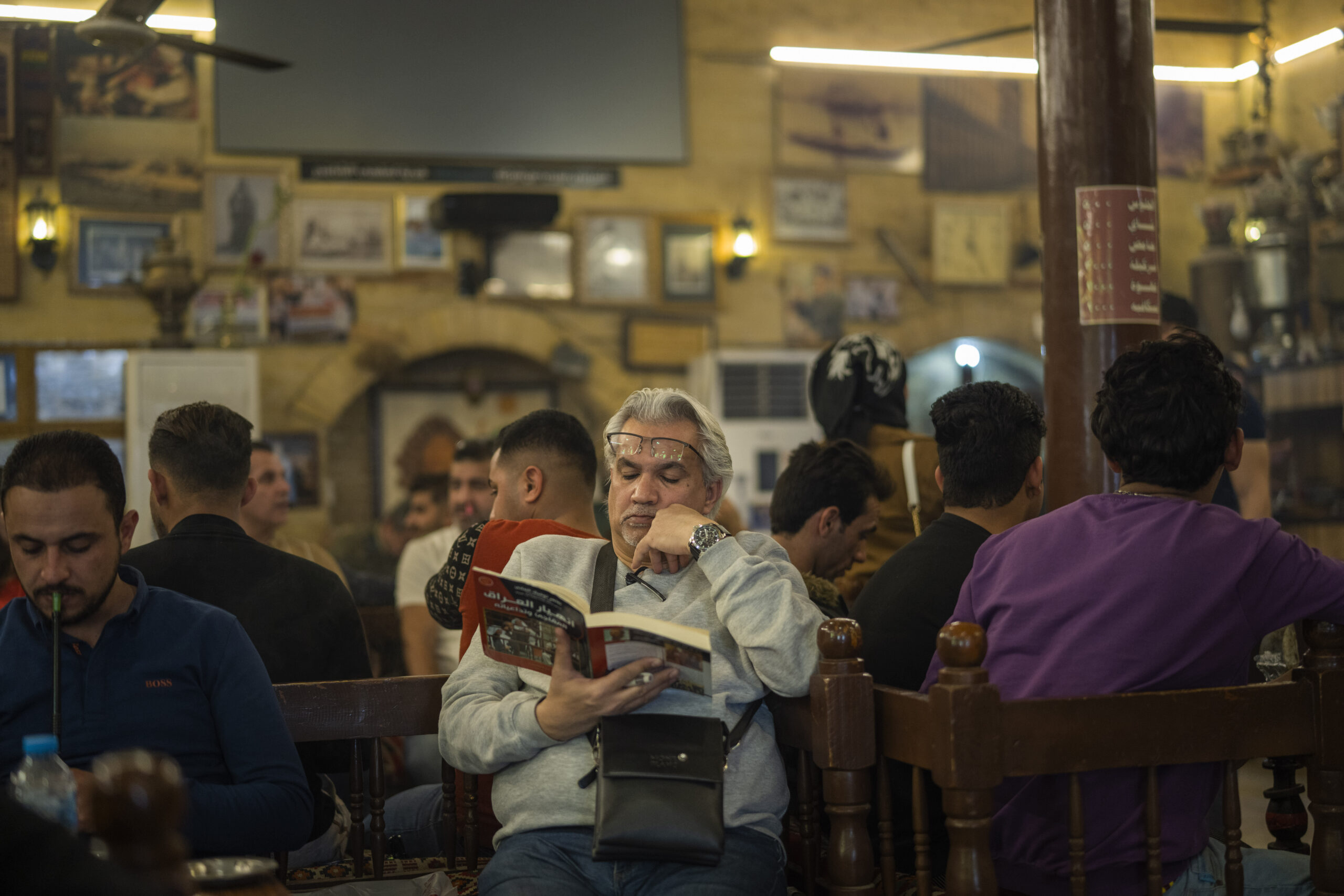 A man reads a book at a cafe in Baghdad, Iraq, Feb. 24. (AP Photo/Jerome Delay)