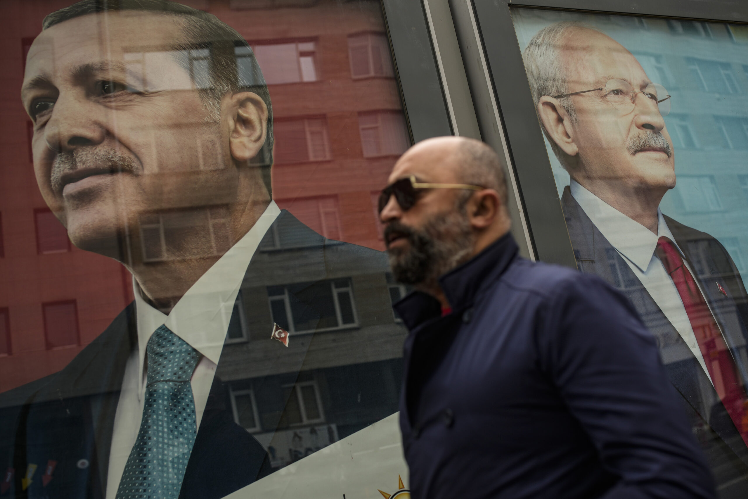 A man walks past election campaign billboards of Turkish President Recep Tayyip Erdogan, the People's Alliance's presidential candidate, left, and Republican People's Party leader Kemal Kilicdaroglu, the Nation Alliance's presidential candidate, in Istanbul, Turkey, May 5. (AP Photo/Emrah Gurel)