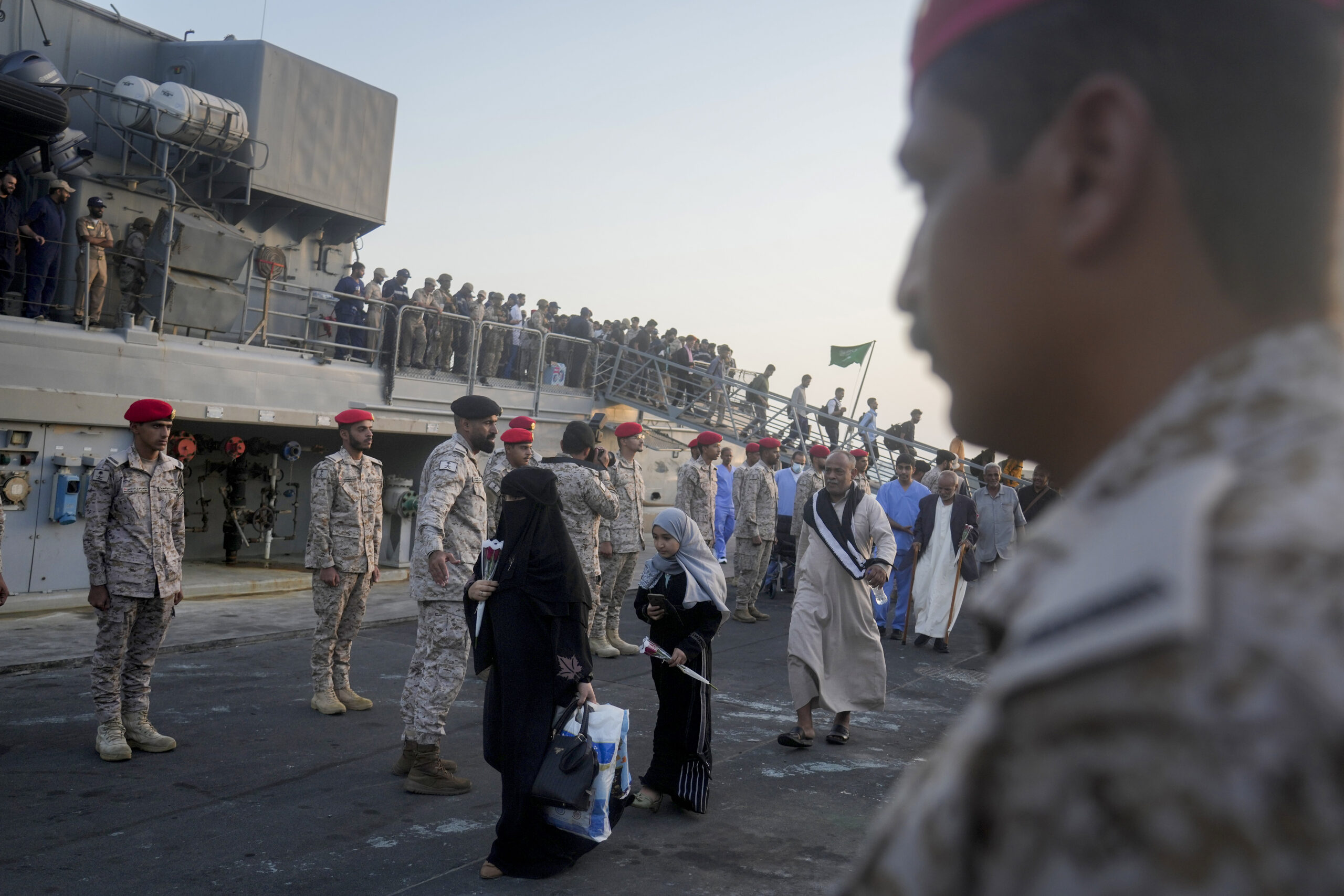 Yemeni evacuees disembark the Saudi ship HMS Abha, coming from Port Sudan, after docking at Jeddah port, Saudi Arabia, Sunday, May 7. (AP Photo/Amr Nabil)