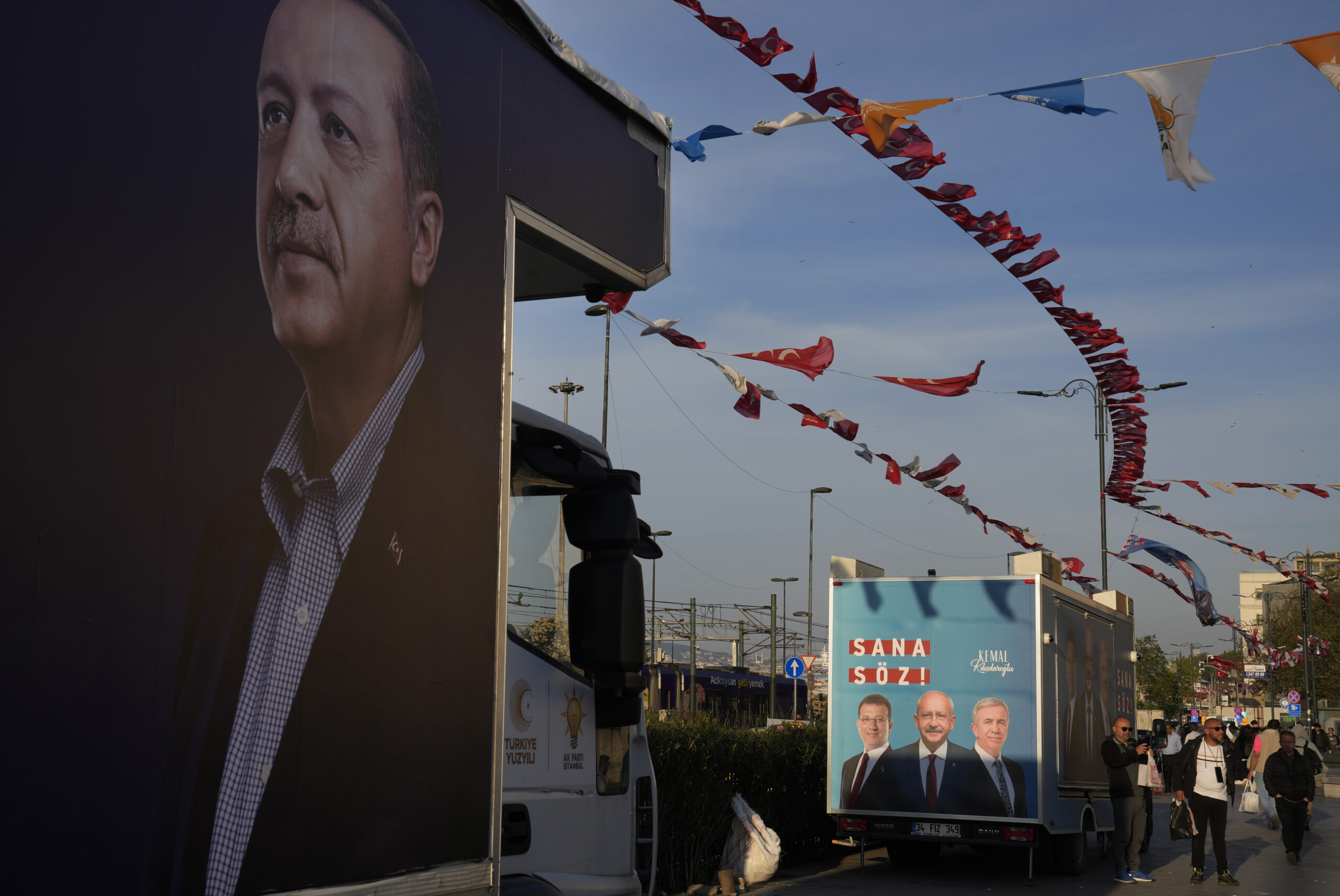 A poster of Turkish President Recep Tayyip Erdogan, the People's Alliance's presidential candidate, left, is displayed on a truck near an election poster of Republican People's Party leader Kemal Kilicdaroglu, the Nation Alliance's presidential candidate, in Istanbul, Turkey, Monday, May 8. (AP Photo/Khalil Hamra)