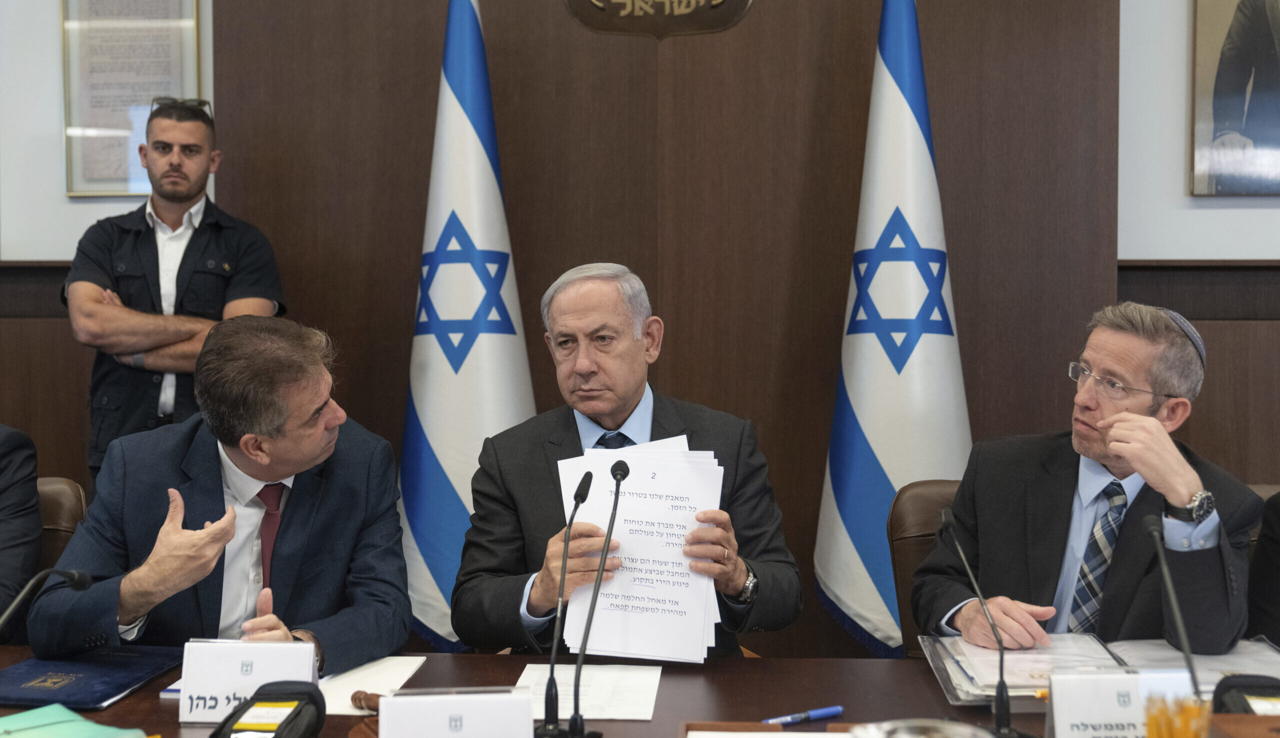 Israeli Prime Minister Benjamin Netanyahu, center, Israeli Foreign Minister Eli Cohen, left, and Cabinet Secretary Yossi Fuchs, right, attend a Cabinet meeting at the prime minister's office in Jerusalem, Monday, July 17. (AP Photo/Ohad Zwigenberg, Pool)