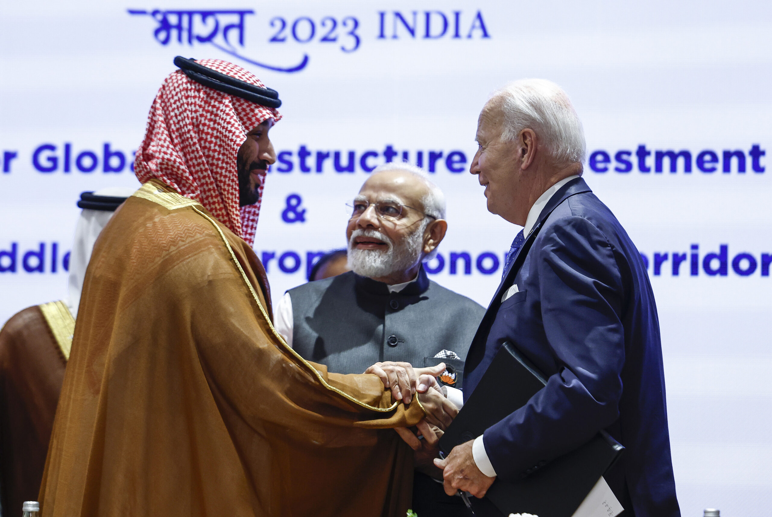 Saudi Arabian Crown Prince Mohammed bin Salman, left, and U.S. President Joseph R. Biden Jr., right, shake hands next to Indian Prime Minister Narendra Modi on the day of the G20 summit in New Delhi, India, Sept. 9. (AP Photo/Evelyn Hockstein, Pool)