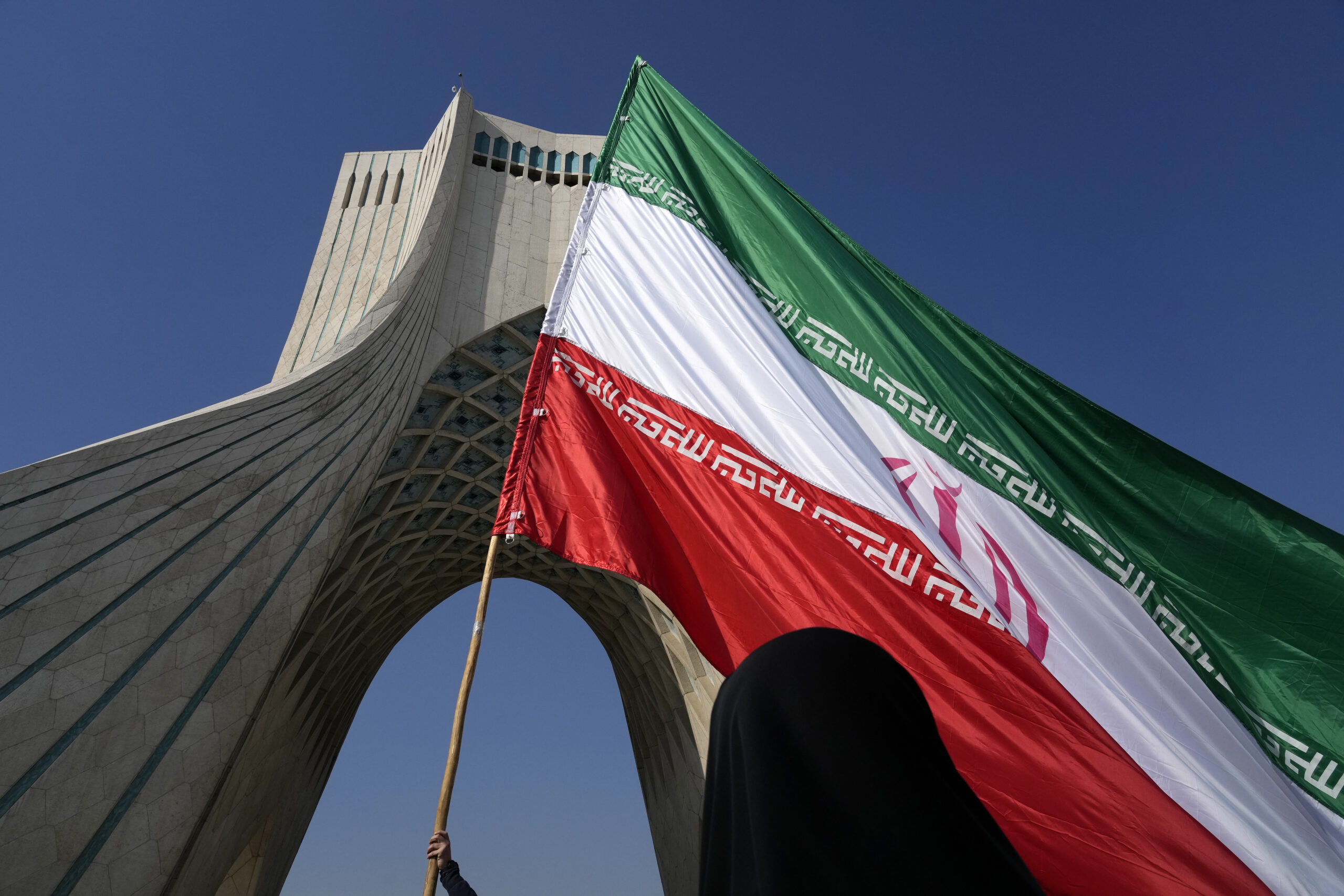 A huge Iranian flag is carried under the Azadi (Freedom) monument tower during the annual rally commemorating Iran's 1979 Islamic Revolution in Tehran, Iran, Feb. 11. (AP Photo/Vahid Salemi)