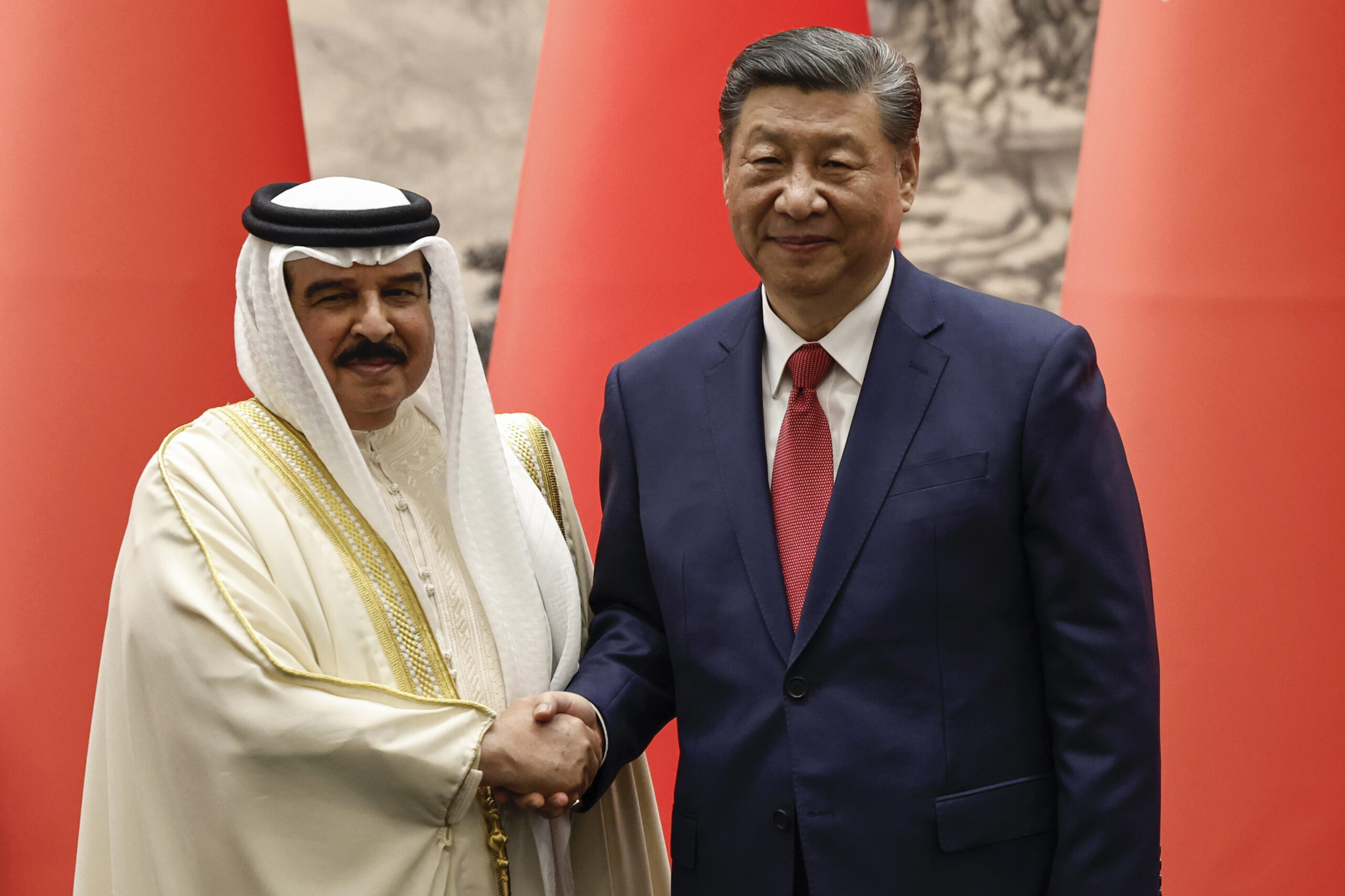 Chinese President Xi Jinping, right, and Bahraini King Hamad bin Isa al-Khalifa shake hands following a signing ceremony at the Great Hall of the People in Beijing, Friday, May 31. (Tingshu Wang/Pool Photo via AP)