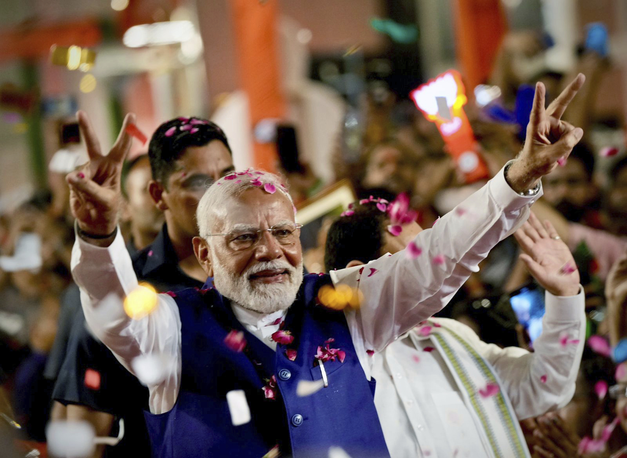Prime Minister Narendra Modi greets supporters as he arrives at Bharatiya Janata Party headquarters in New Delhi, India, Tuesday, June 4. (AP Photo/Manish Swarup)
