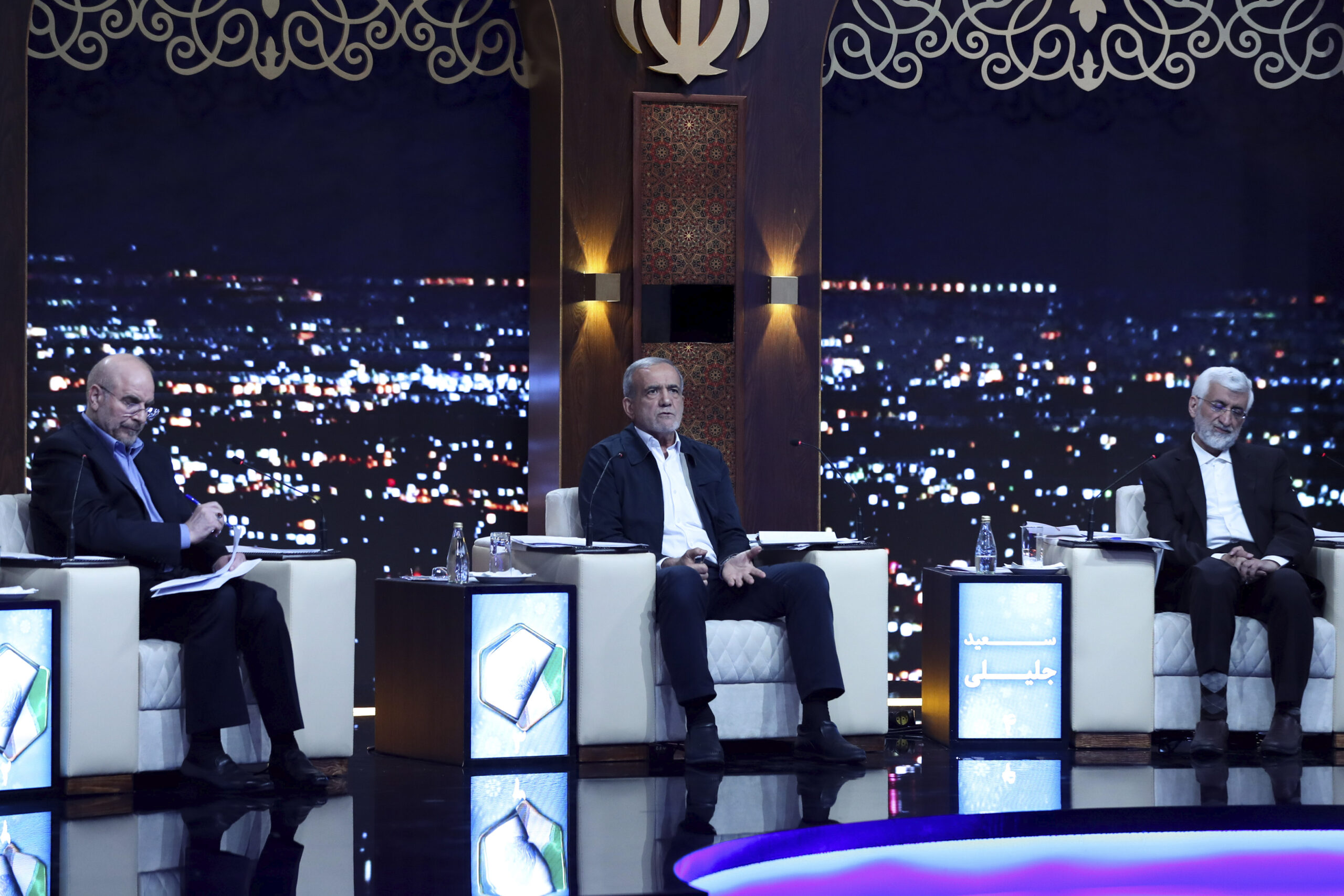 Reformist presidential candidate Masoud Pezeshkian, center, a member of parliament, speaks in a debate of the candidates as Mohammad-Bagher Qalibaf, left, and Saeed Jalili listen at a TV studio in Tehran, Iran, June 17. (Morteza Fakhri Nezhad/IRIB via AP)
