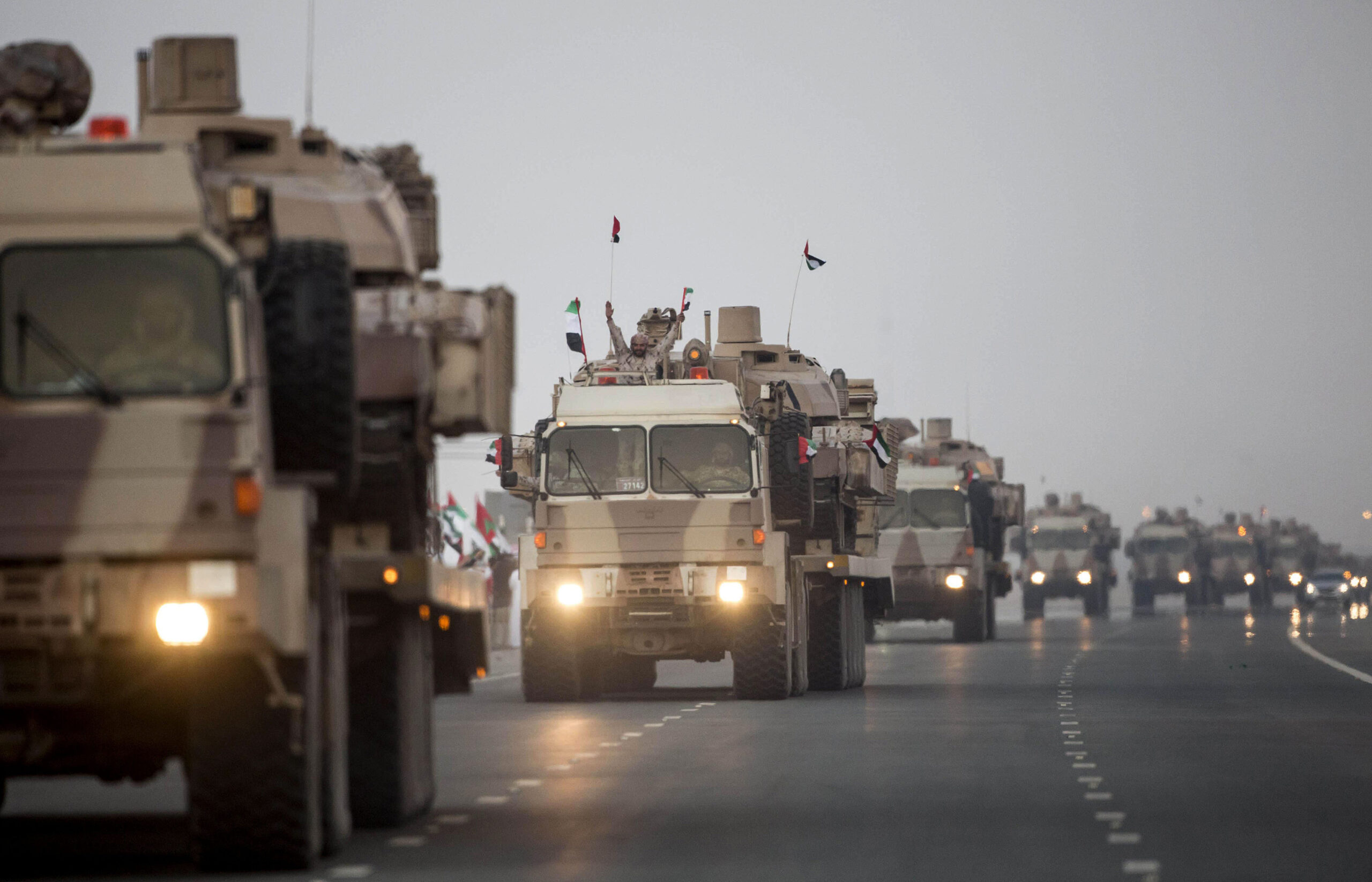 A convoy of UAE military vehicles and personnel travels from Al Hamra Military Base to Zayed Military City, marking the return of the first batch of UAE Armed Forces military personnel from Yemen, in Abu Dhabi, United Arab Emirates, Nov. 7, 2015. (Ryan Carter, Crown Prince Court – Abu Dhabi/WAM via AP)